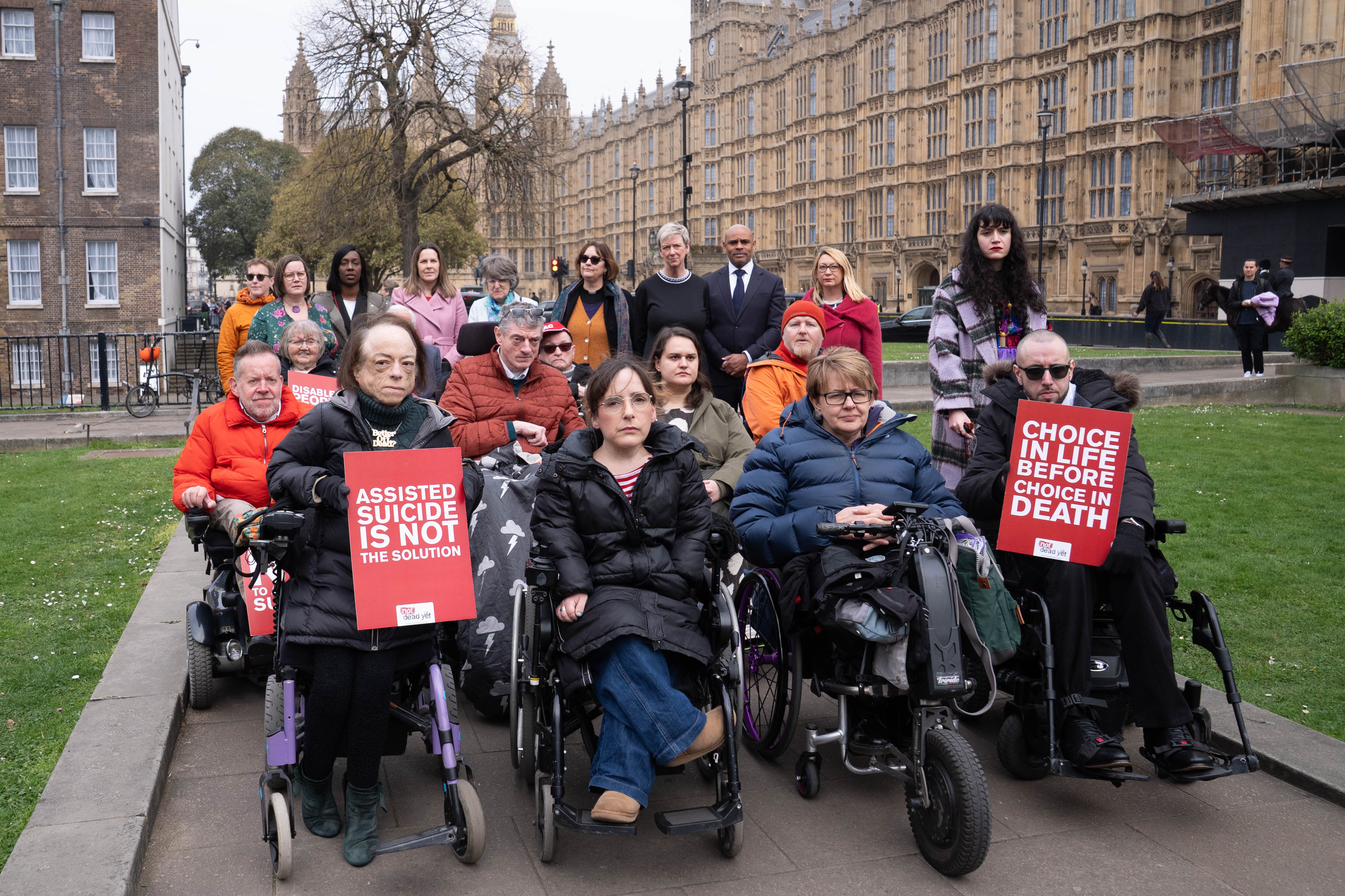 Campaigners including actress Liz Carr and Baroness Grey-Thompson outside parliament (Stefan Rousseau/PA)