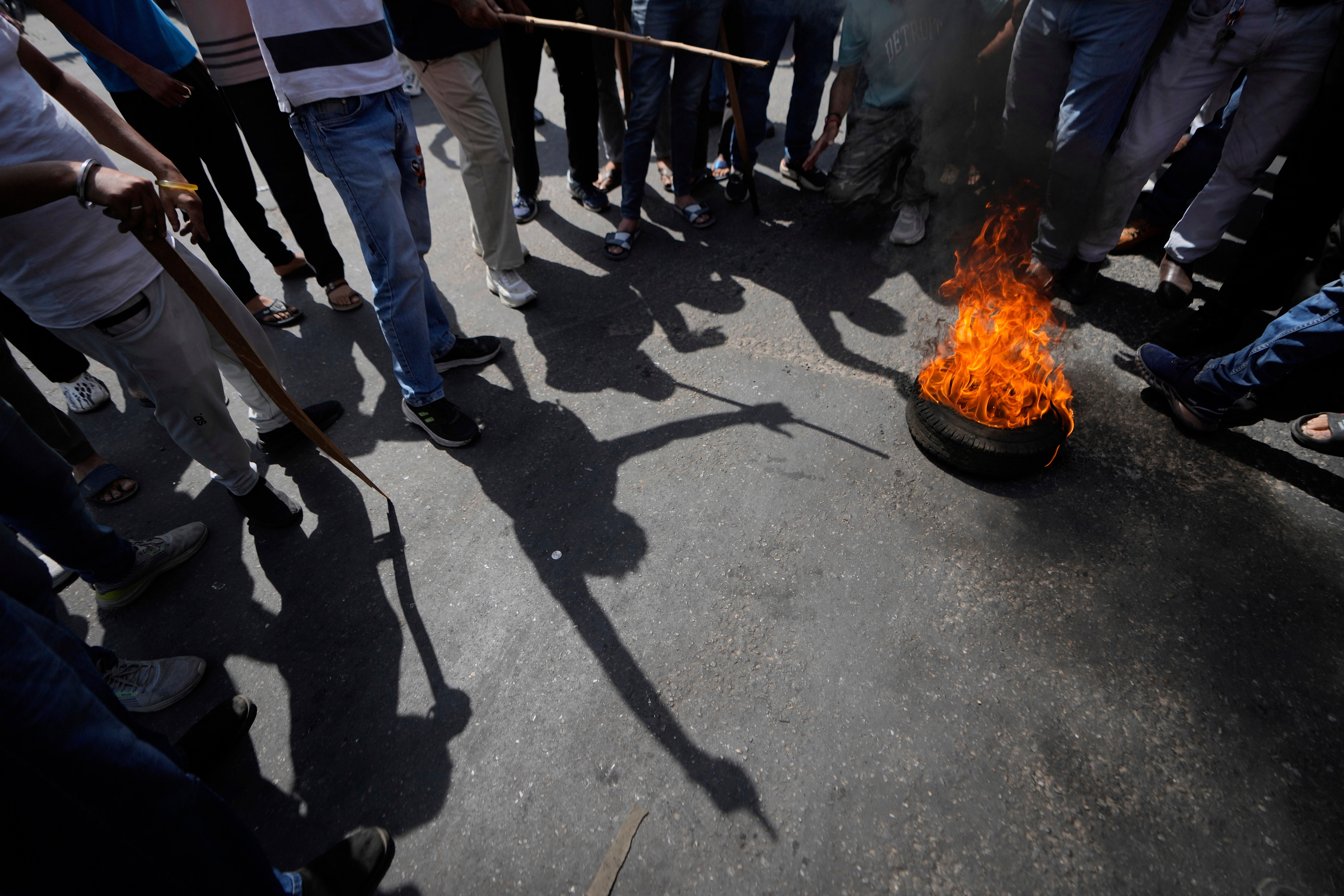 File: Members of Bajrang Dal burn tiers during a protest in Jammu