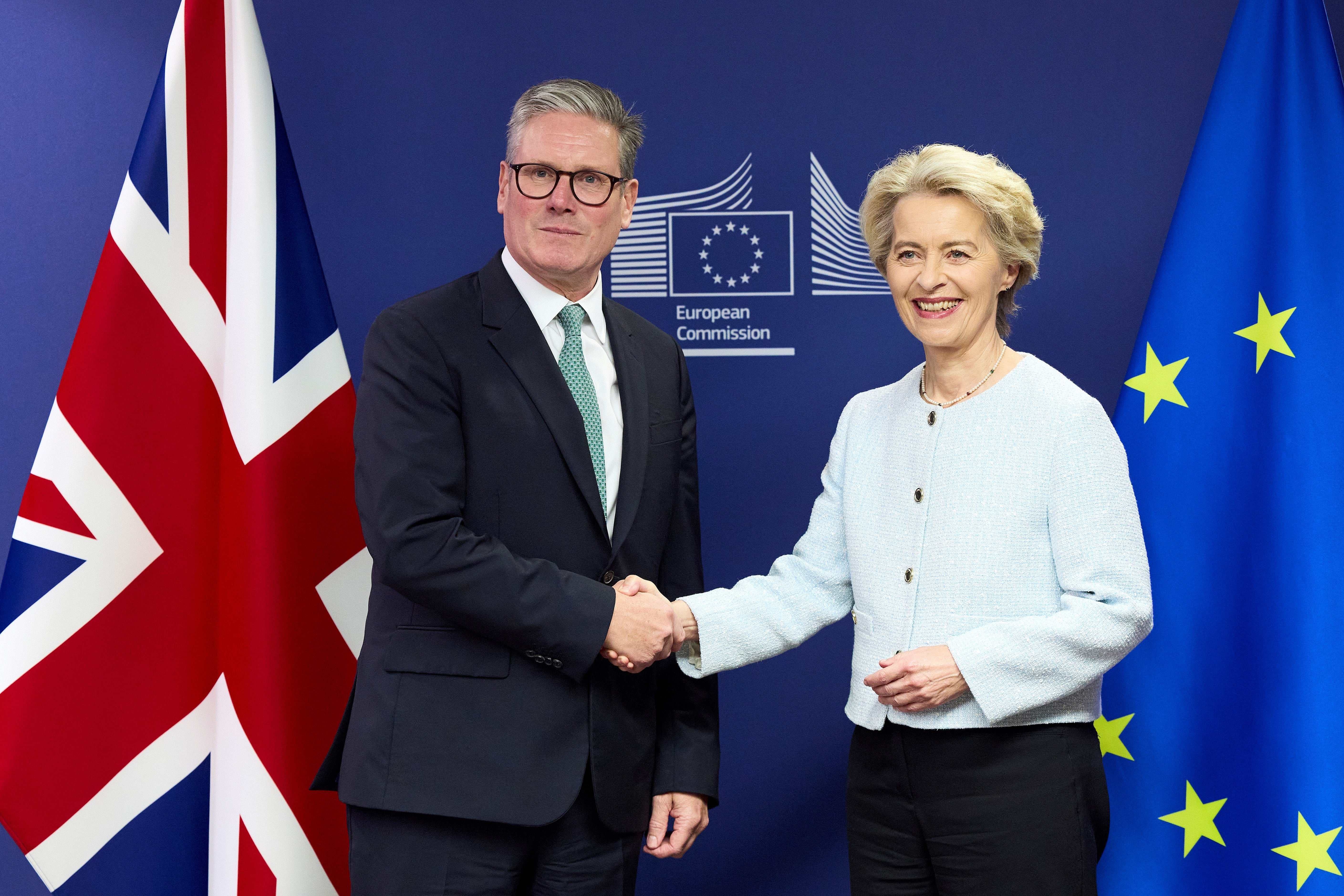Sir Keir Starmer shakes hands with Ursula von der Leyen in front of UK and EU flags