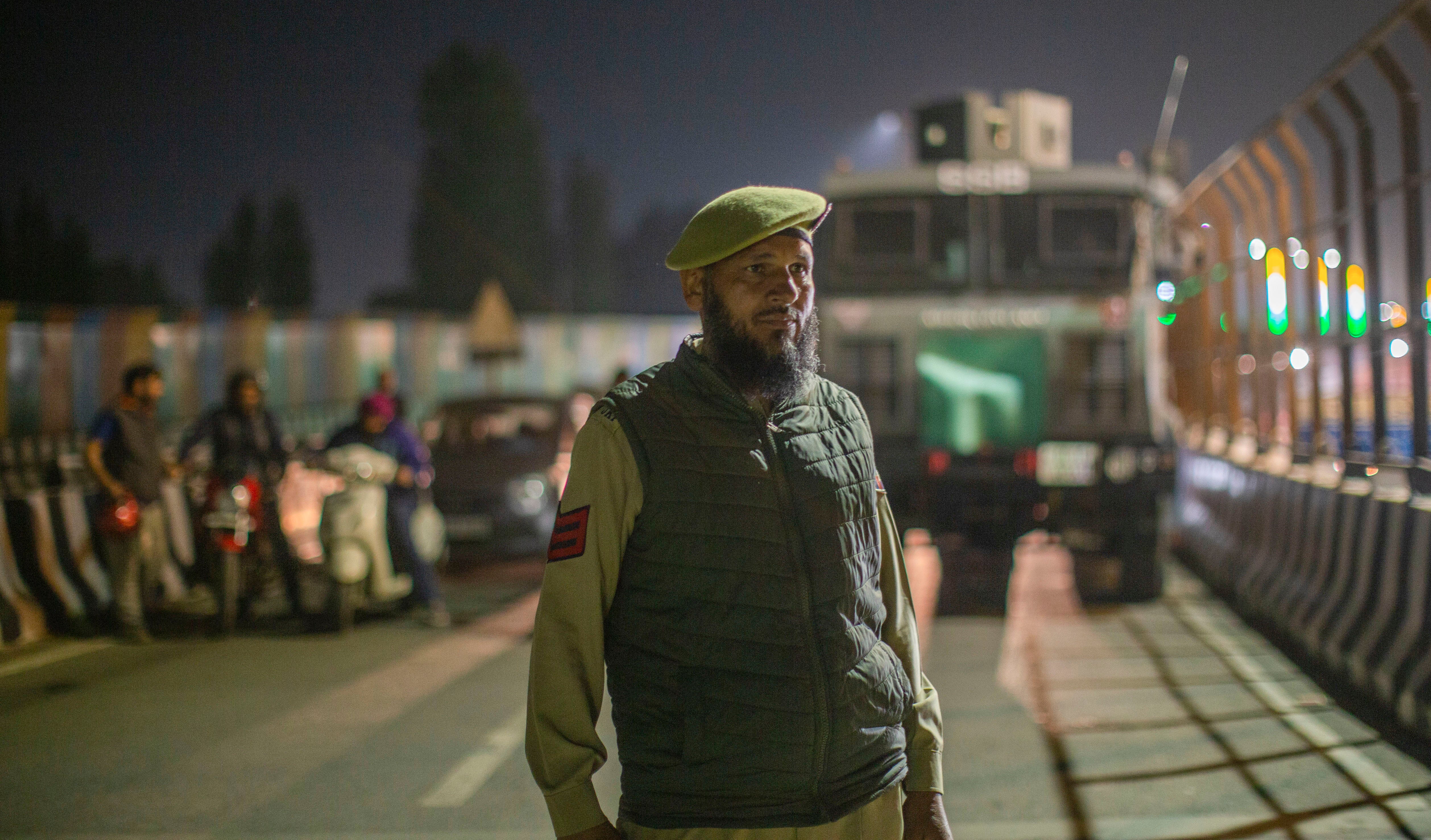 A policeman stops traffic to make way for Indian home minister Amit Shah’s cavalcade on his arrival in Kashmir