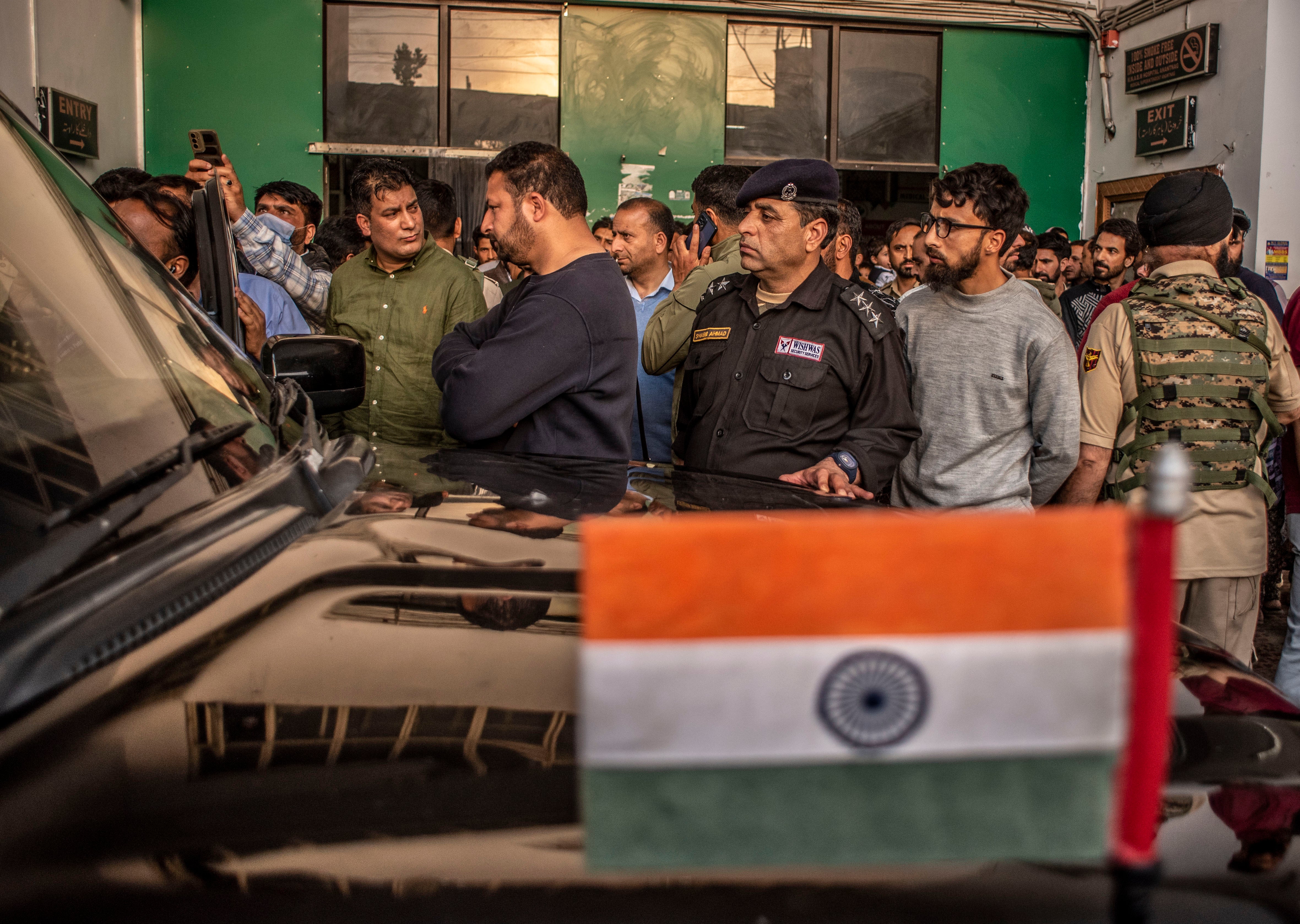 Local Kashmiris and Indian police, along with armed forces, gather outside the hospital to receive the dead and wounded after gunmen attacked Indian tourists