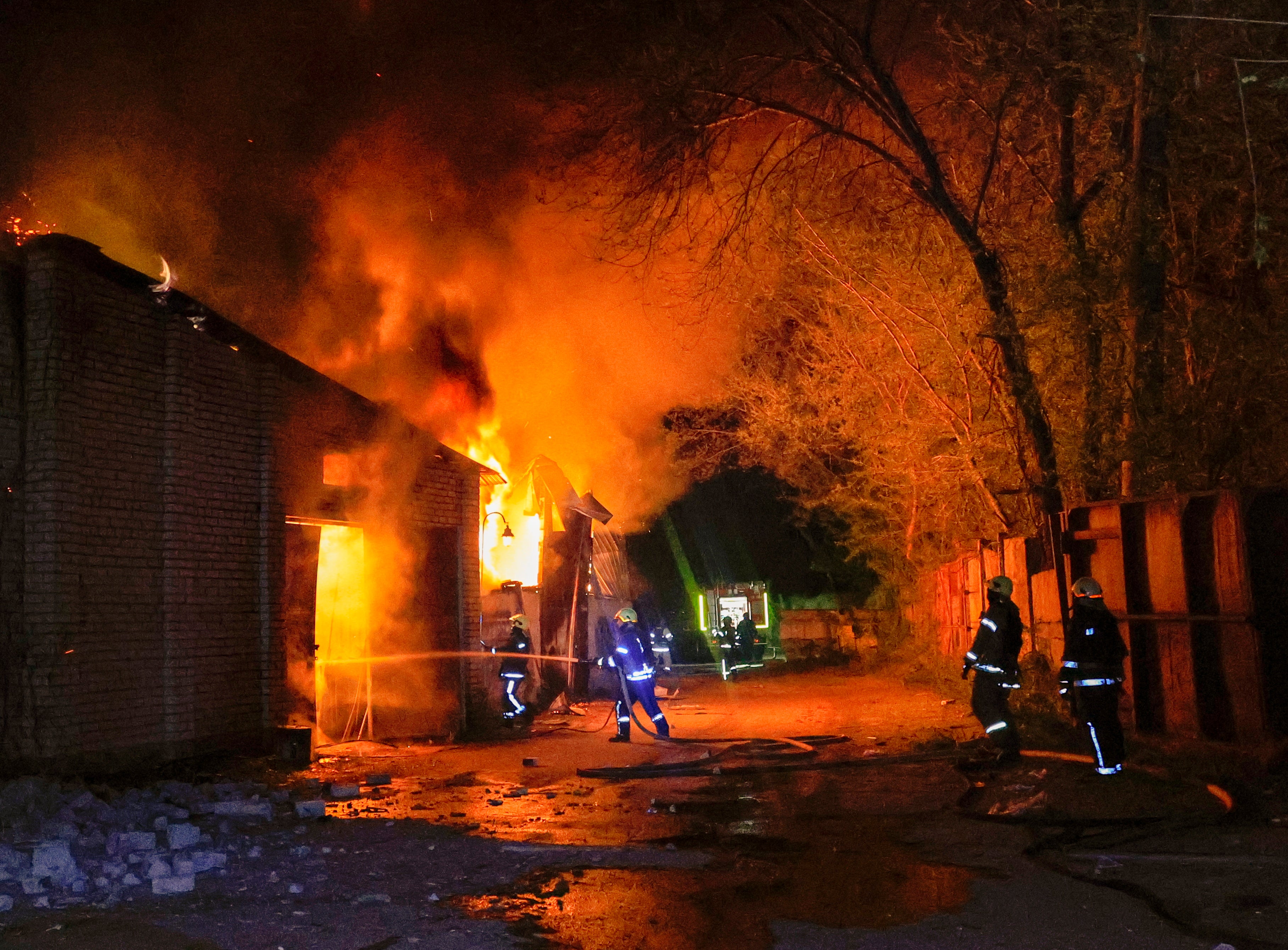 Rescuers work at the site of a drone strike in Kharkiv, Ukraine, on 23 April 2025