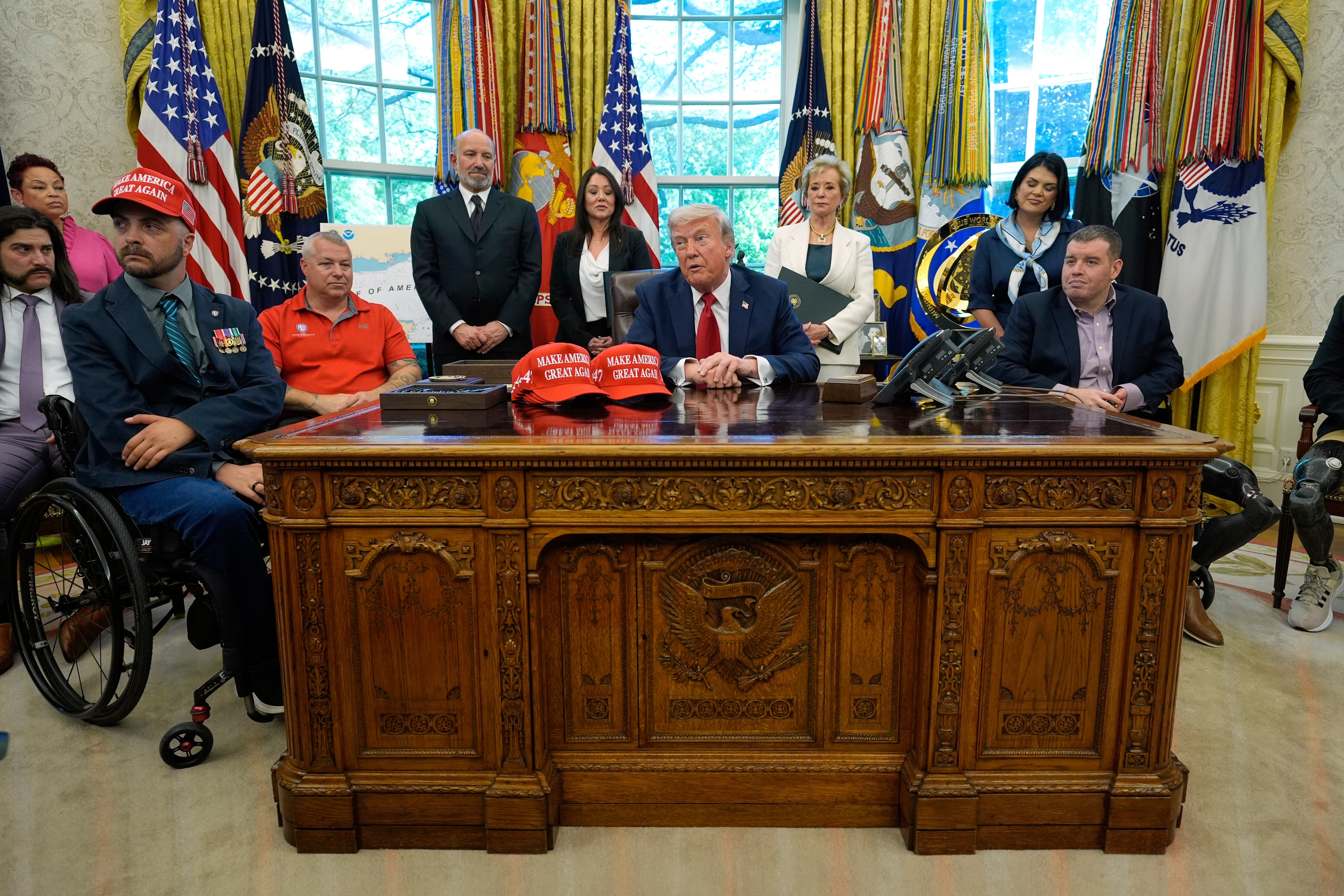Donald Trump sat at the Resolute Desk after signing executive orders in the Oval Office on April 23