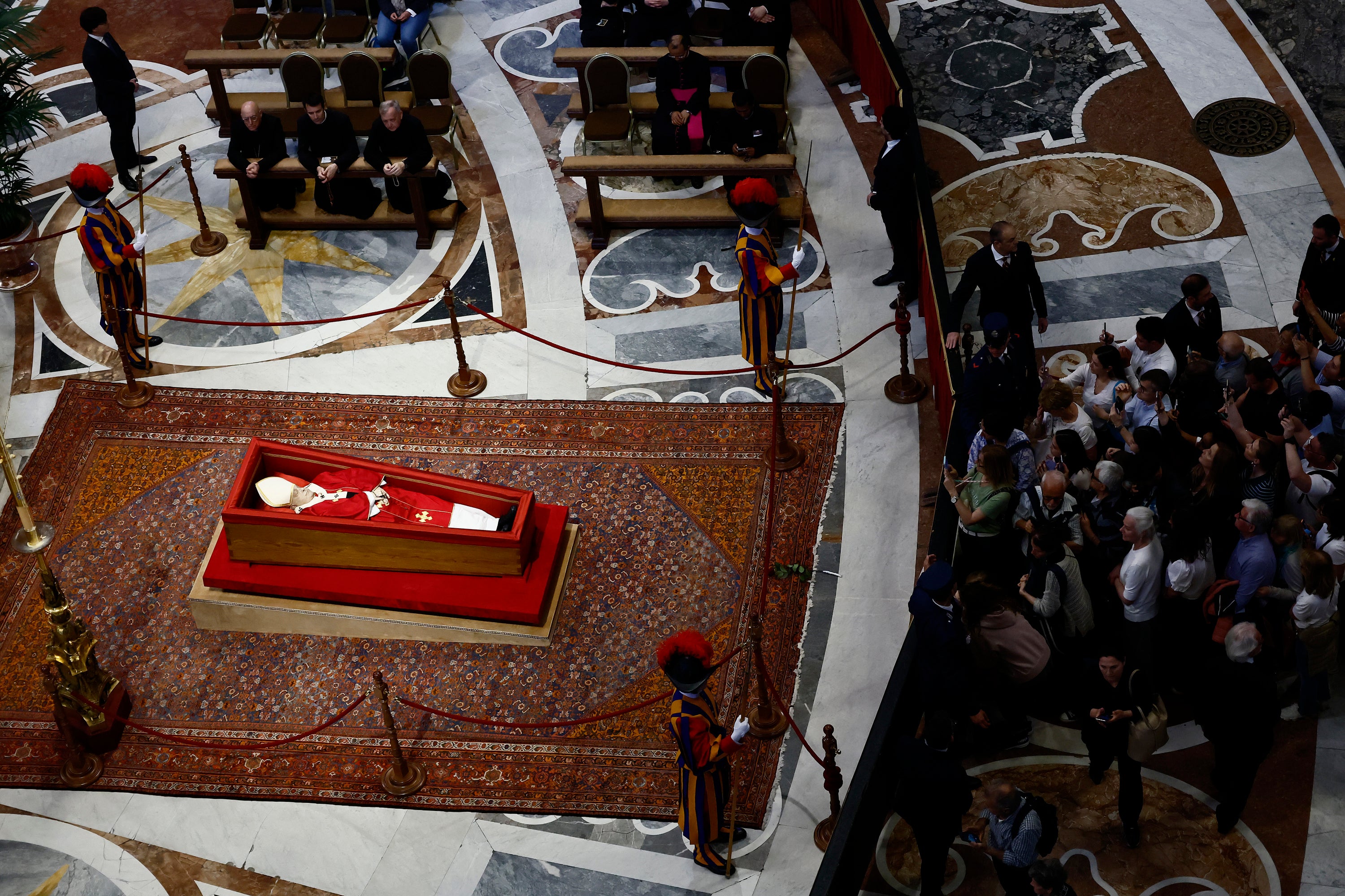 People queue to pay their respects to the late Pope Francis, who will lie in state at St. Peter's Basilica for three days