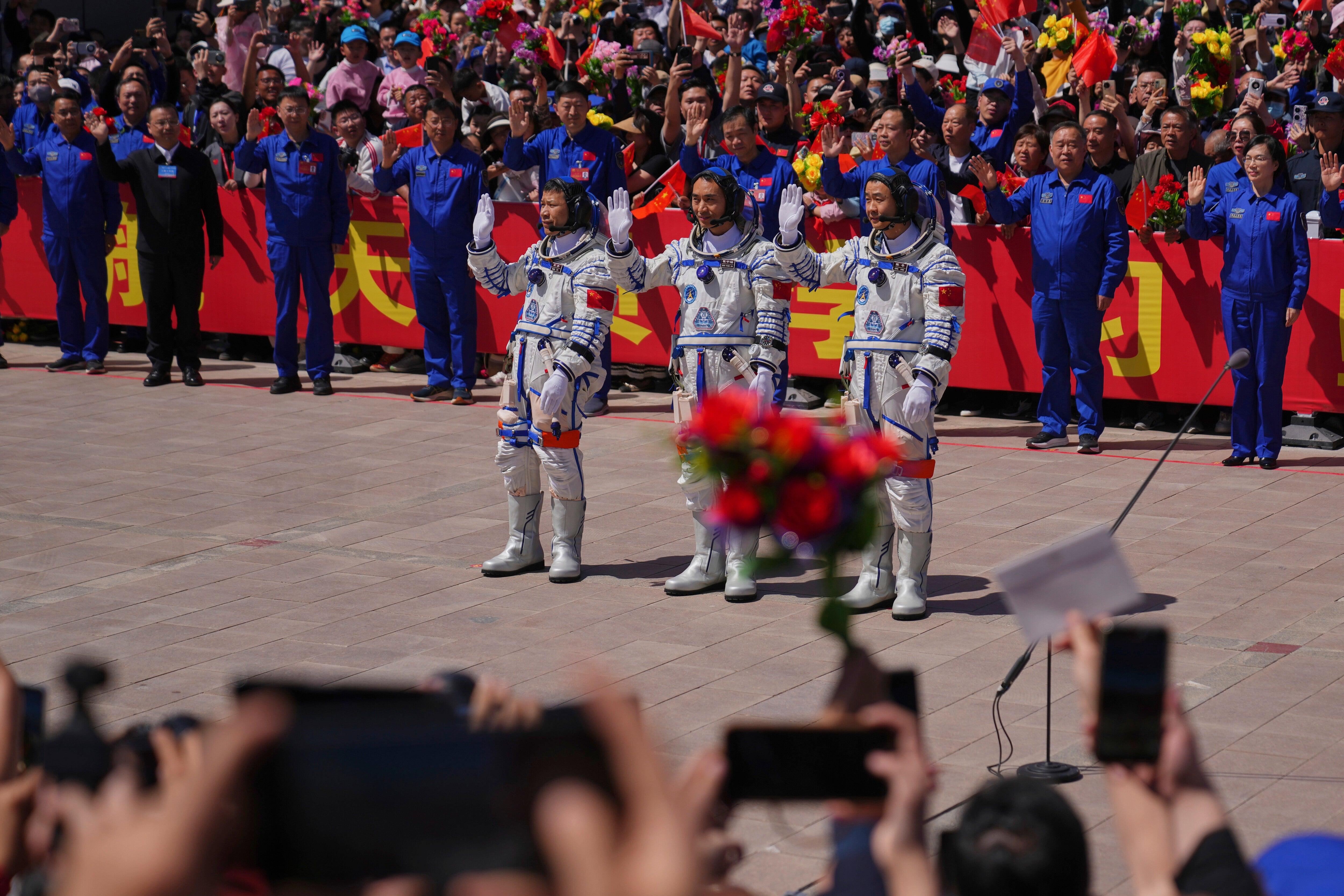 Chinese astronauts for the Shenzhou-20 mission, from right, Chen Zhongrui, Chen Dong and Wang Jie wave as they attend a send-off ceremony for their manned space mission at the Jiuquan Satellite Launch Center in northwestern China, Thursday, 24 April, 2025