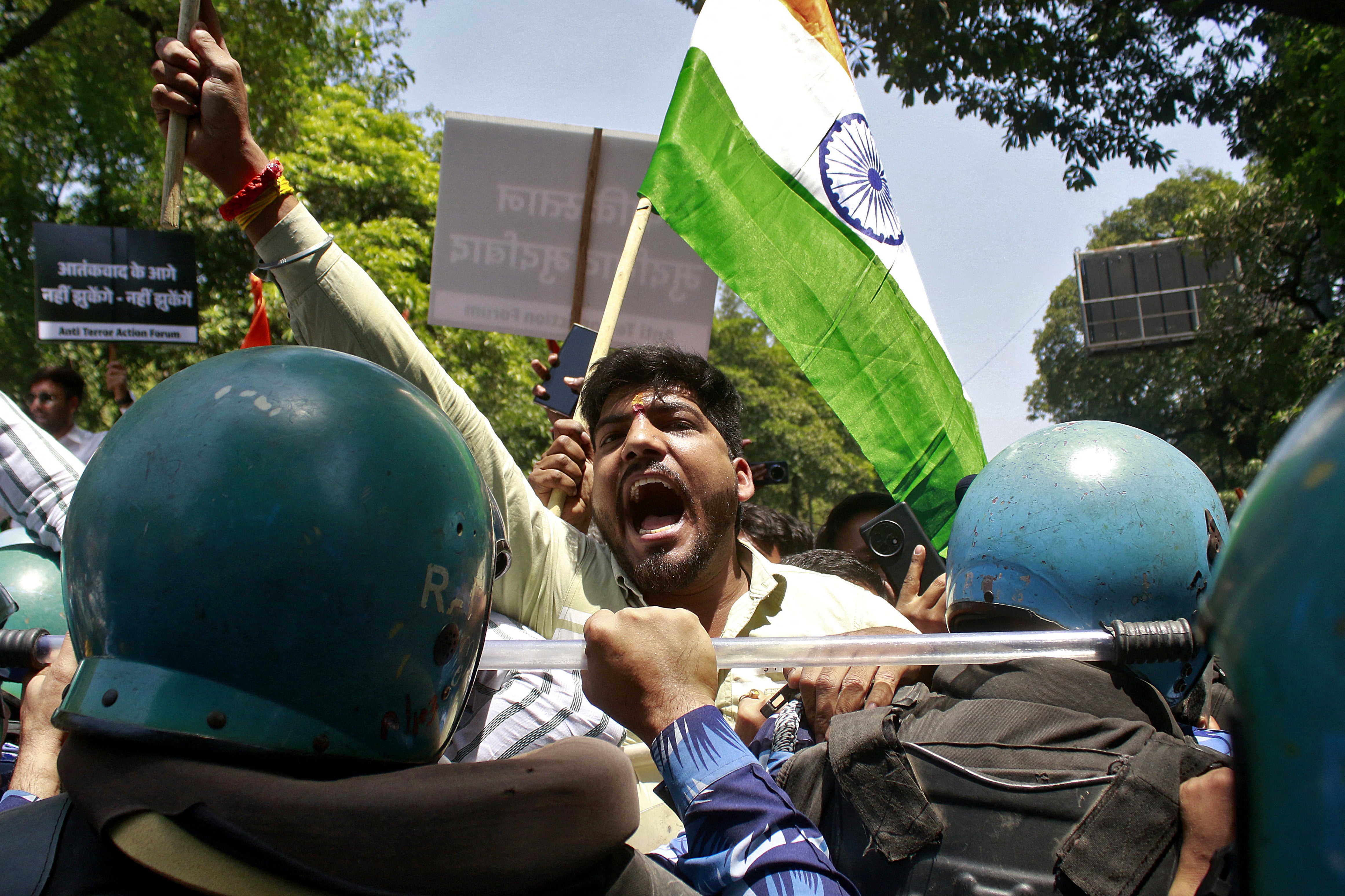 A demonstrator shouts slogans as he is stopped by police during a protest against the Pahalgam attack in New Delhi