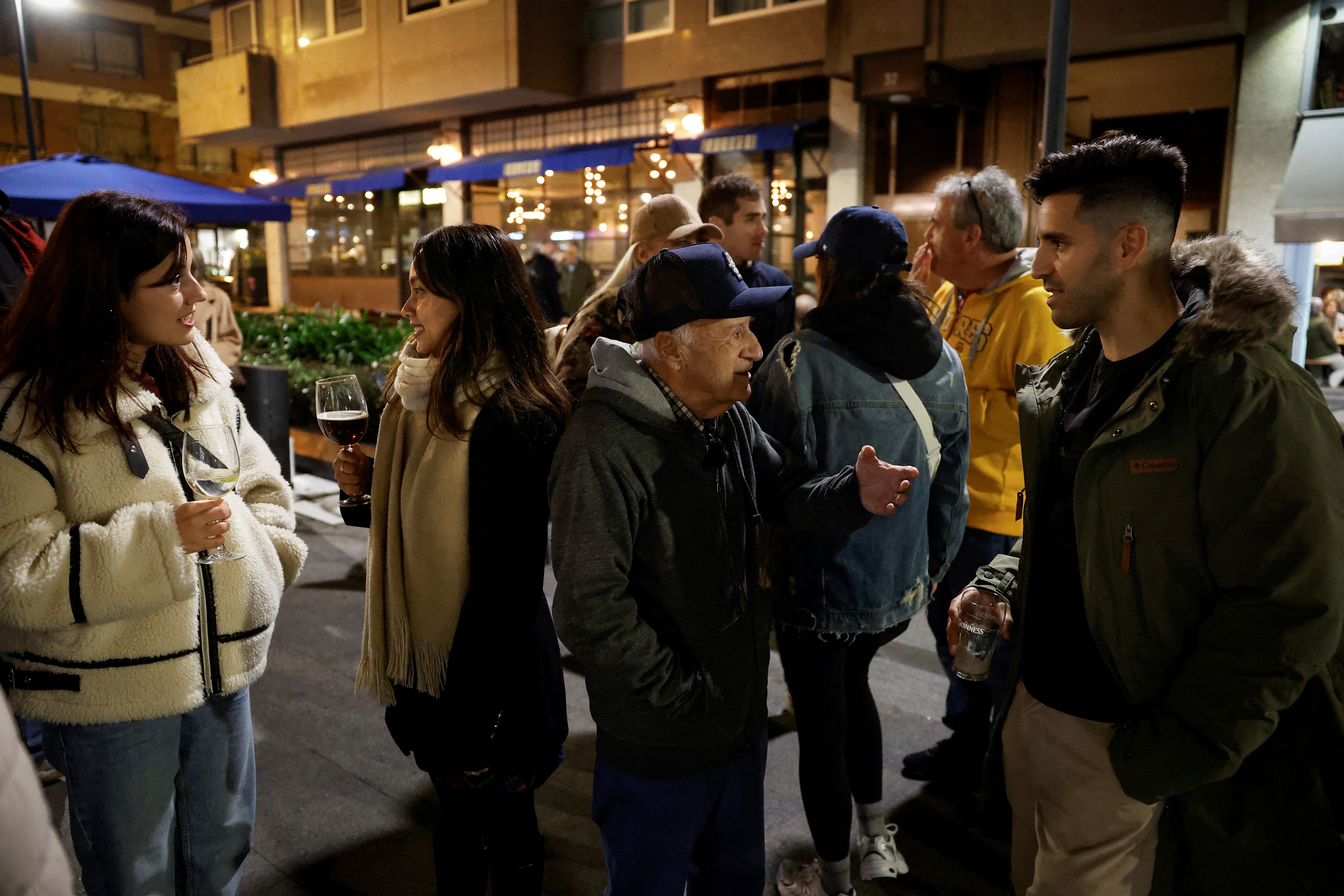 Albizu chats with customers at the Wicklow Arms, where he meets for a weekly session of English conversation classes
