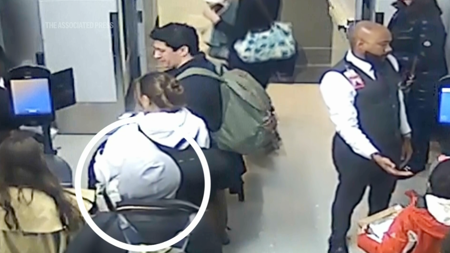 Dali, now wearing a grey hoodie, heads towards the plane