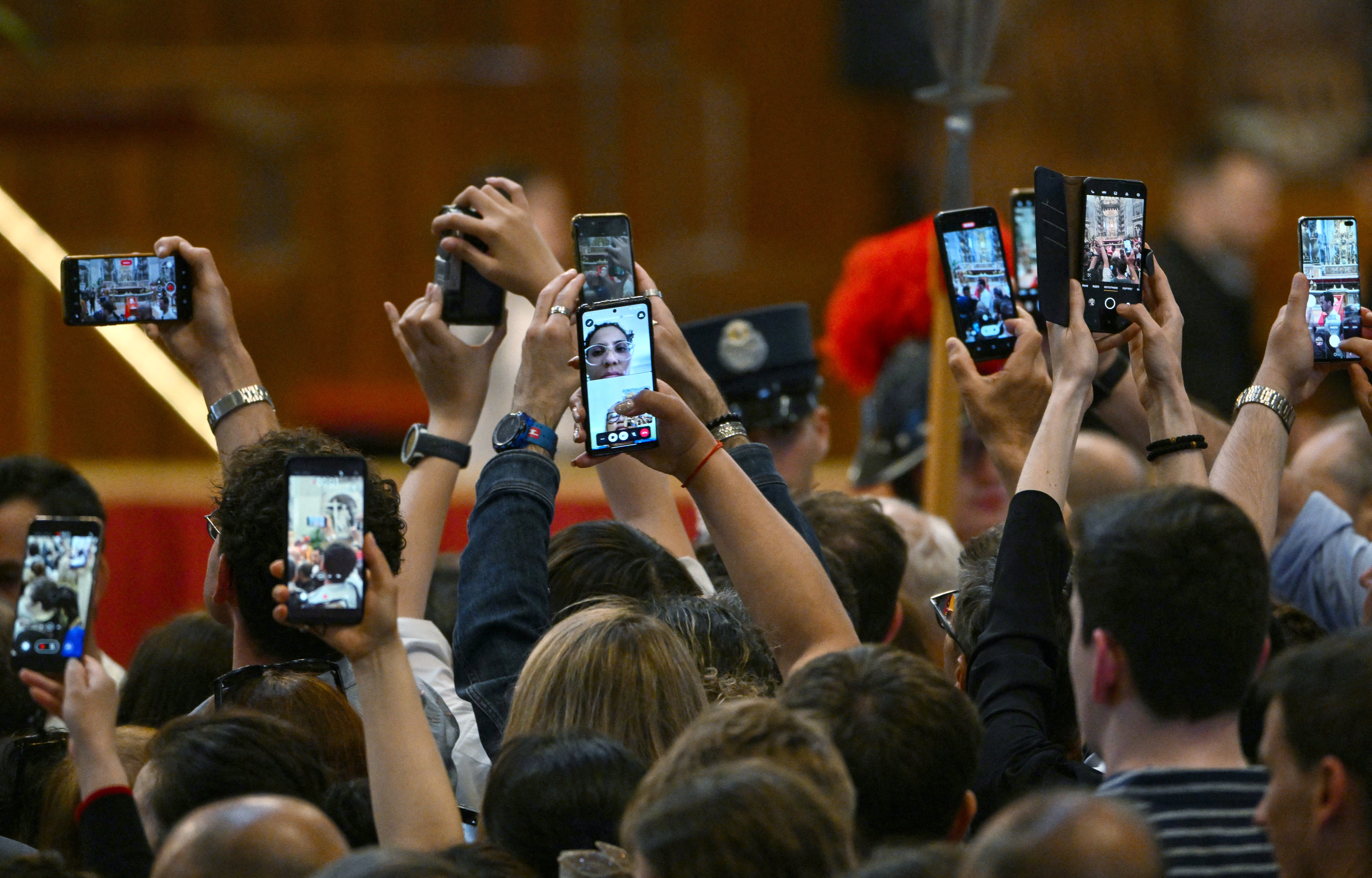 Visitors took out their smartphones to take pictures of the pope in his coffin