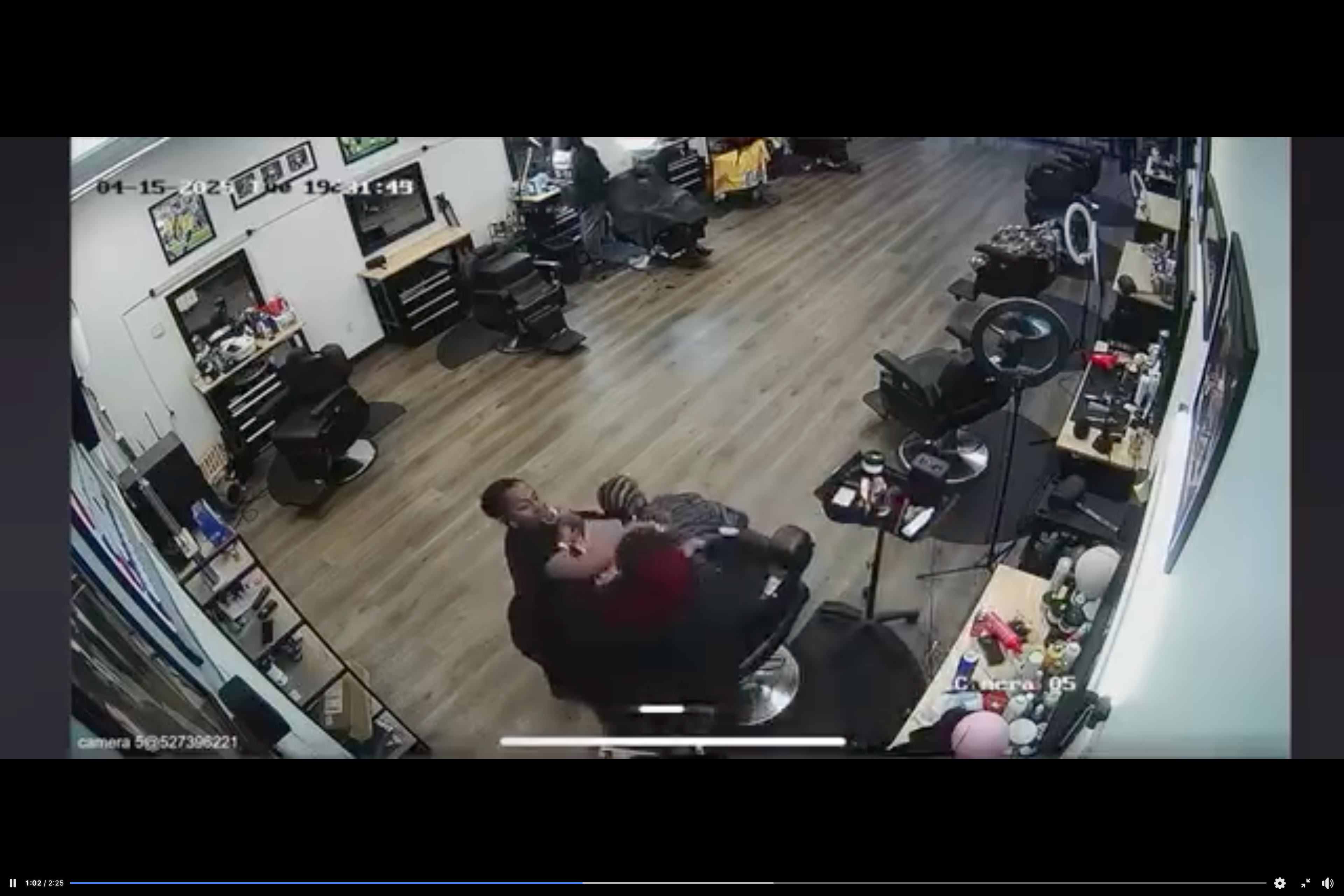 The hairdresser still tries to cut the braids, prompting the mother to swing her daughter's hair forward and farther away from the stylist