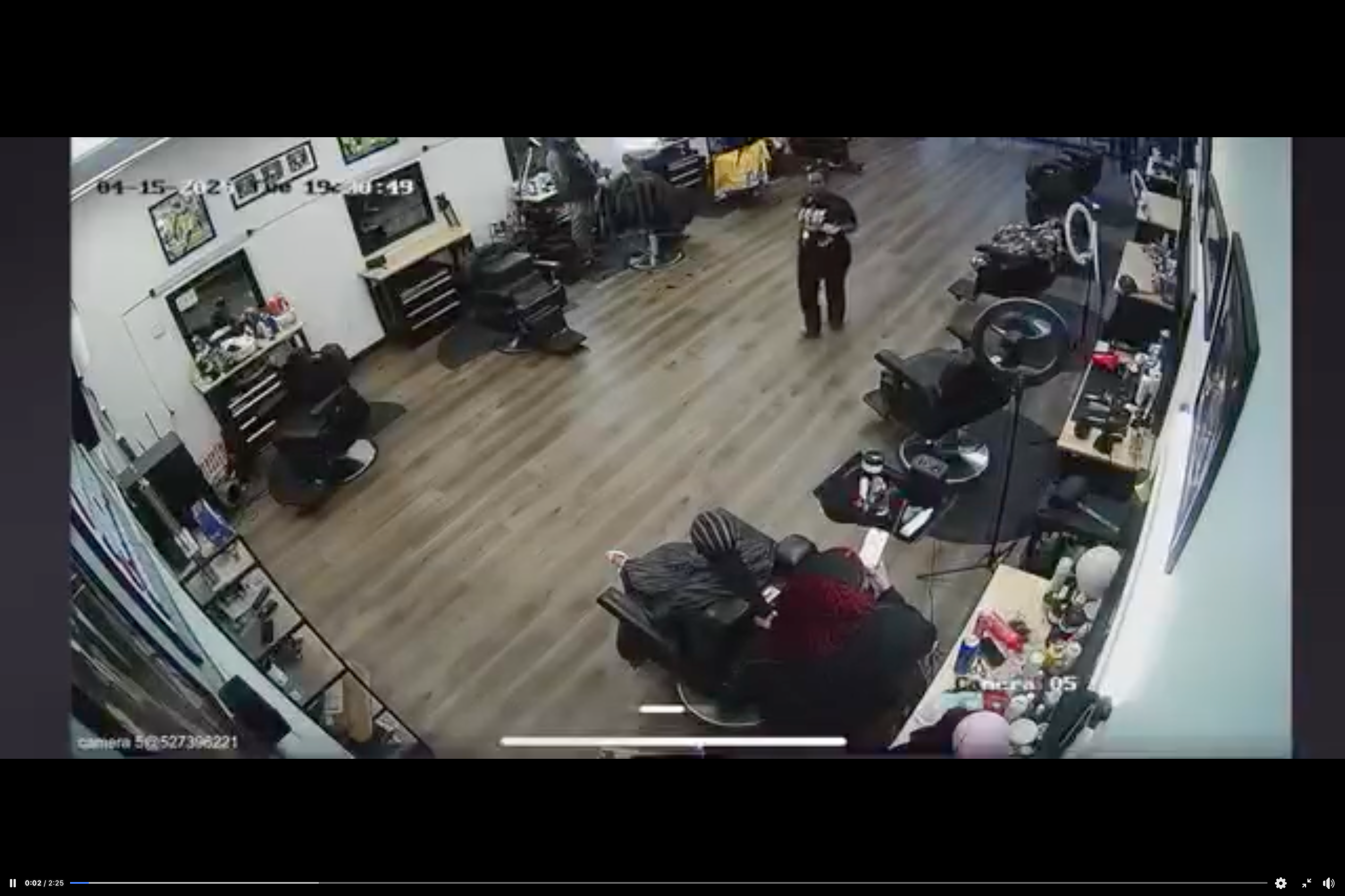 A mother bats the scissors away from her daughter's hair as the stylist tries to cut the 11-year-old’s fresh braids, footage shows, in a dispute over a late fee payment. The video starts with the mom walking up to the child and the hairdresser.