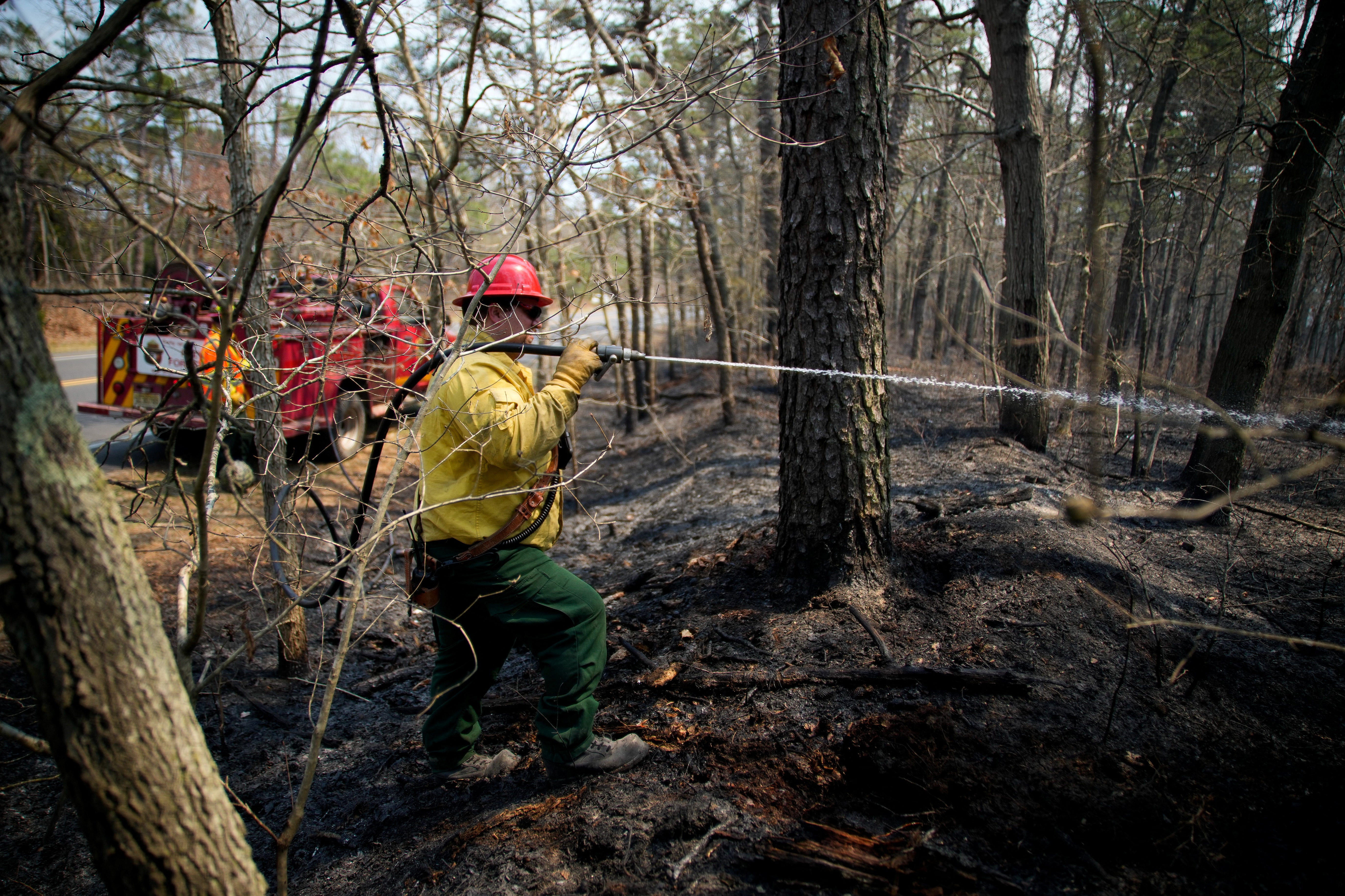 The blaze has destroyed a commercial building and multiple outbuildings and vehicles. Eight other structures remain threatened, and a complete damage assessment is underway