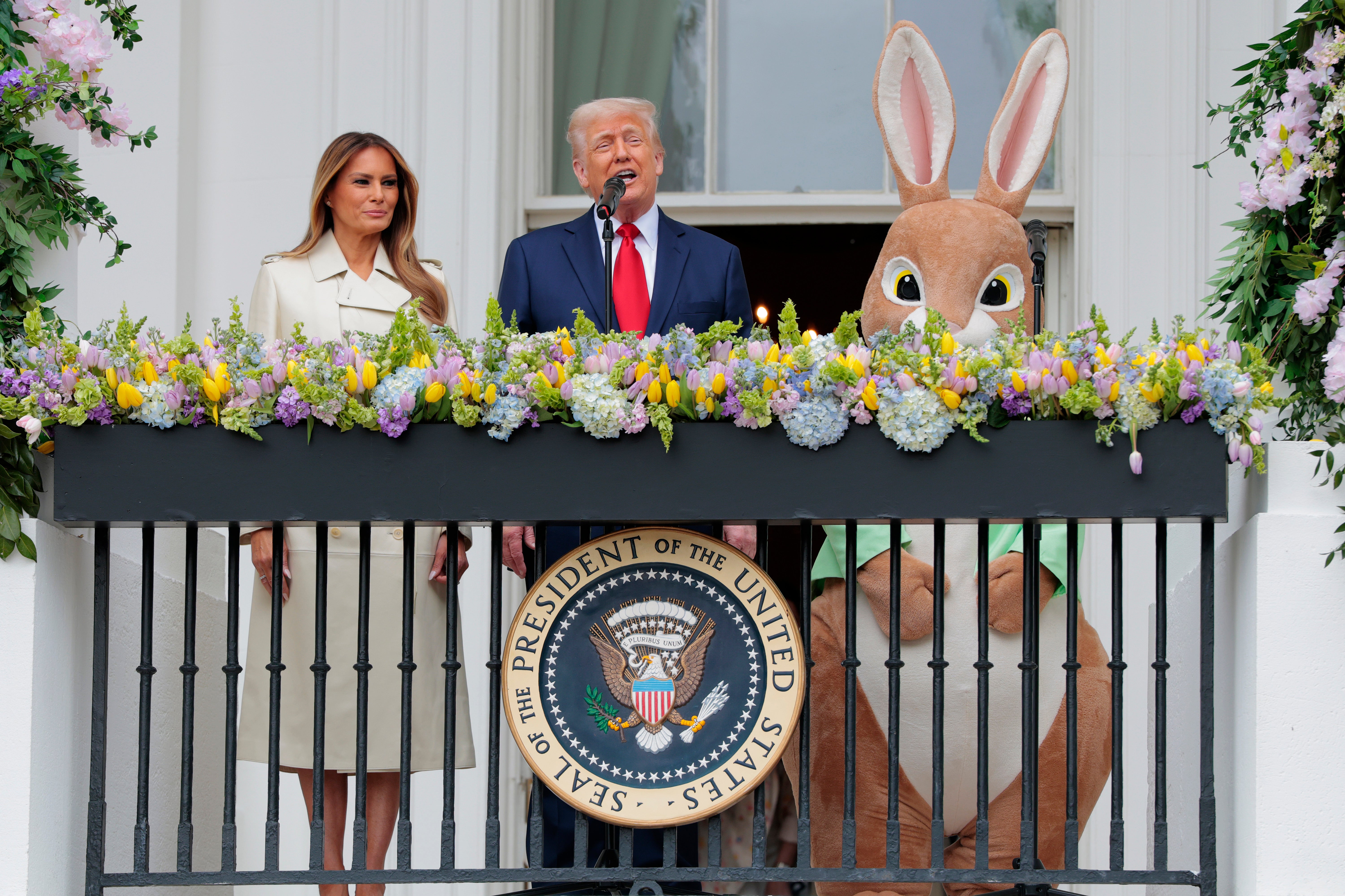 As the Trumps appeared on the presidential balcony to address crowds at the annual White House Easter Egg Roll, they were joined by a large rabbit mascot