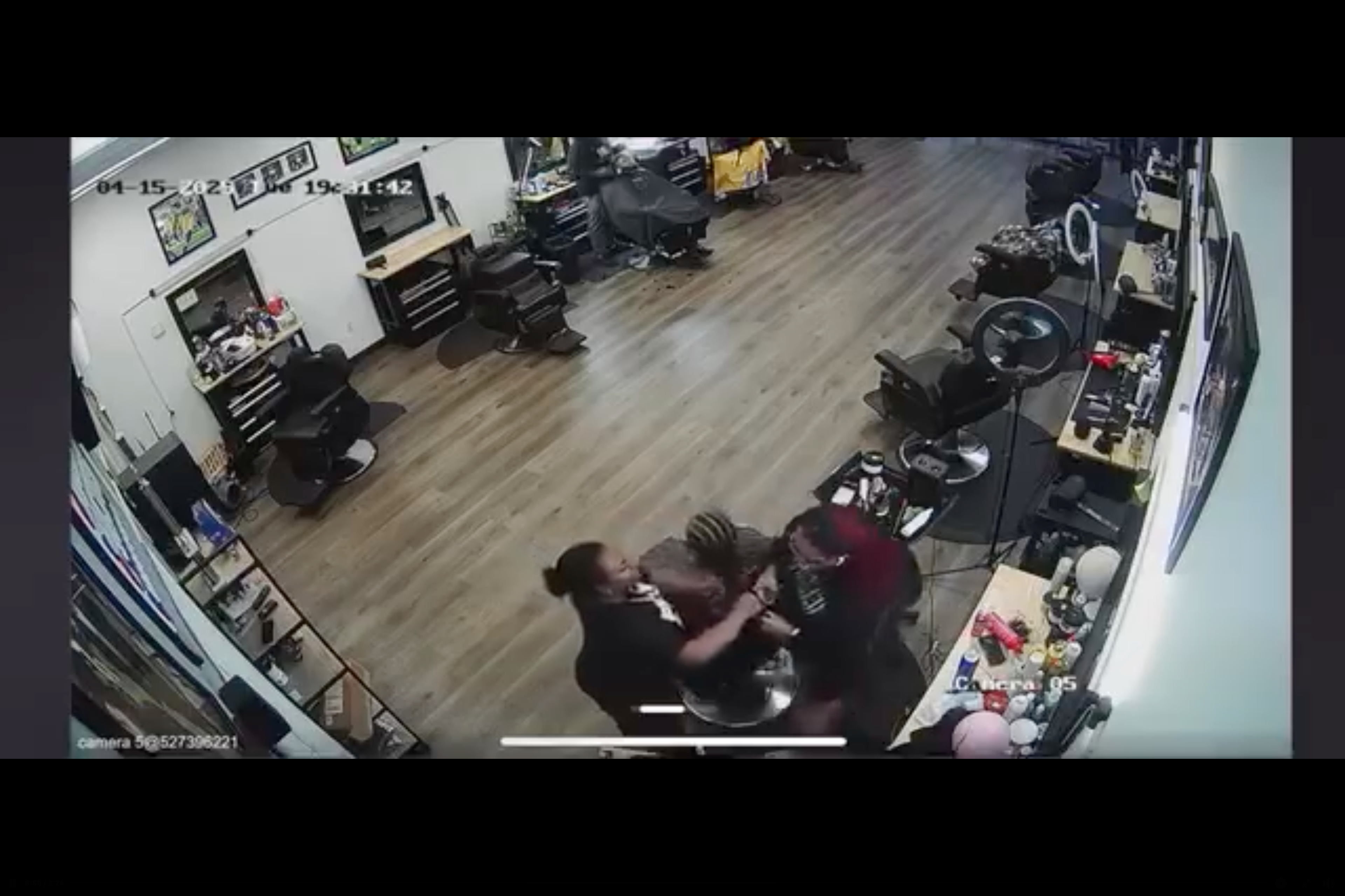 The stylist pulls the braids toward her, starting what looks like a tug-of-war