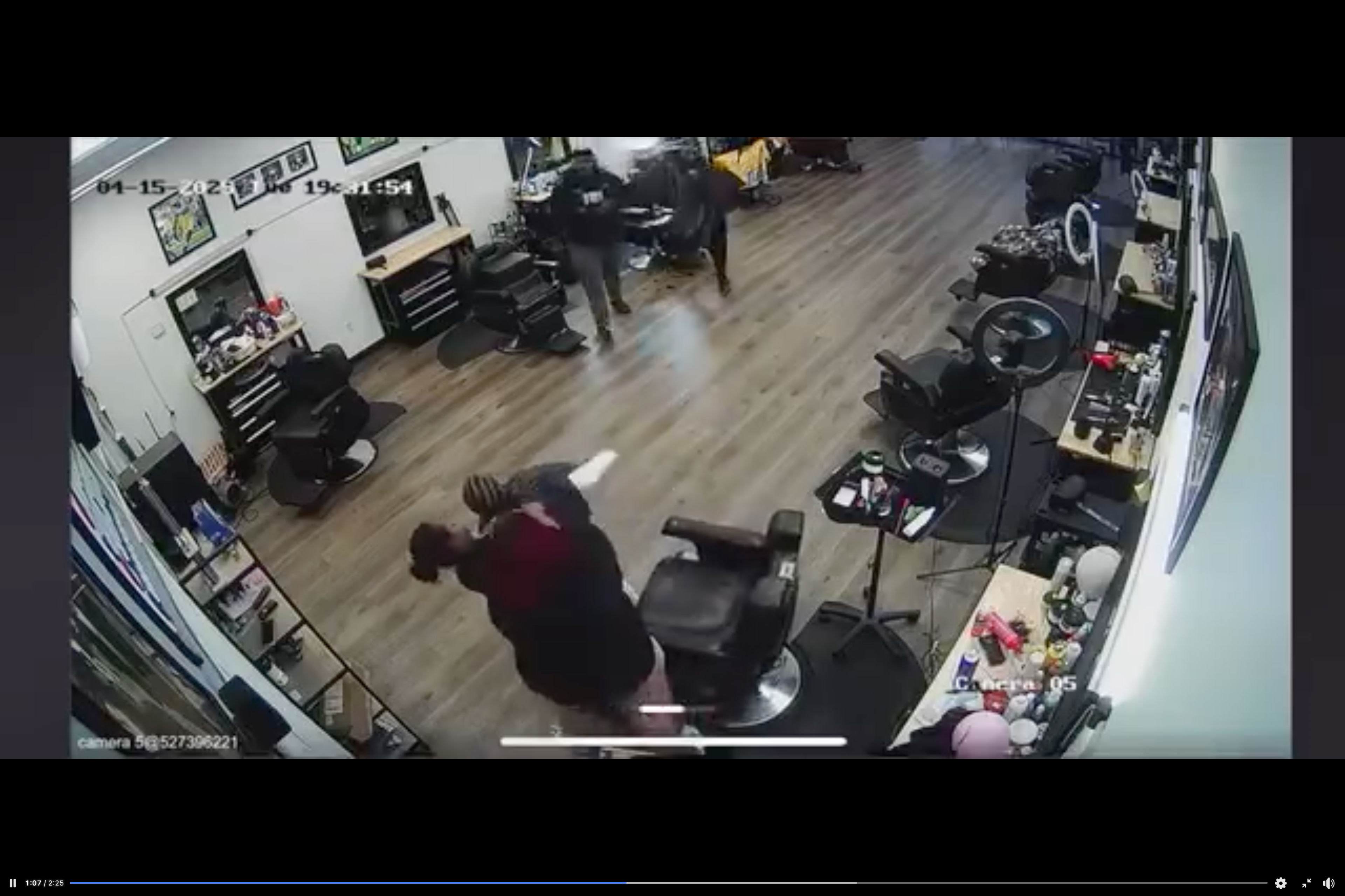 The girl now stands in front of the chair as the altercation continues