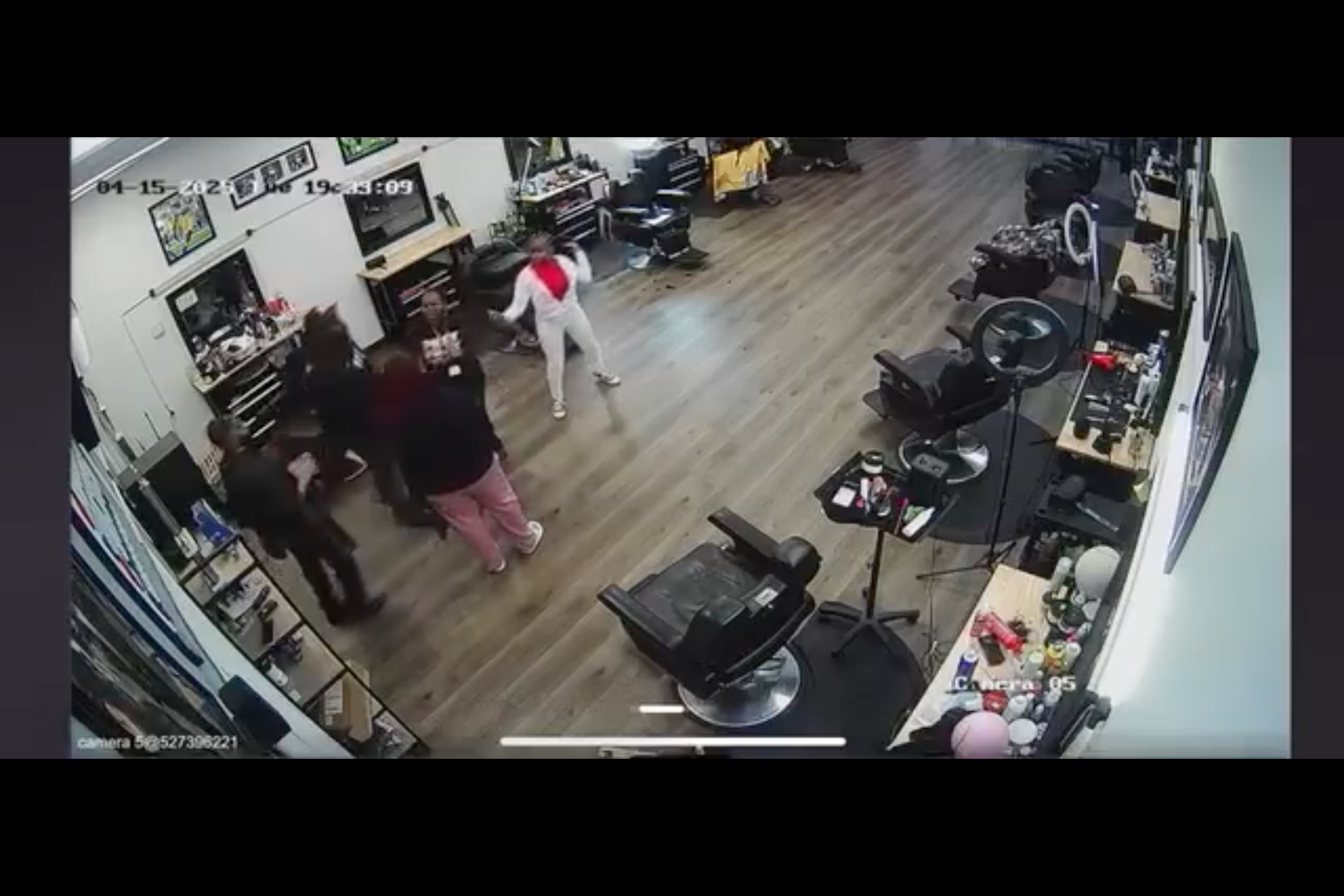 The child pulls her mom away from the argument and closer to the door to leave