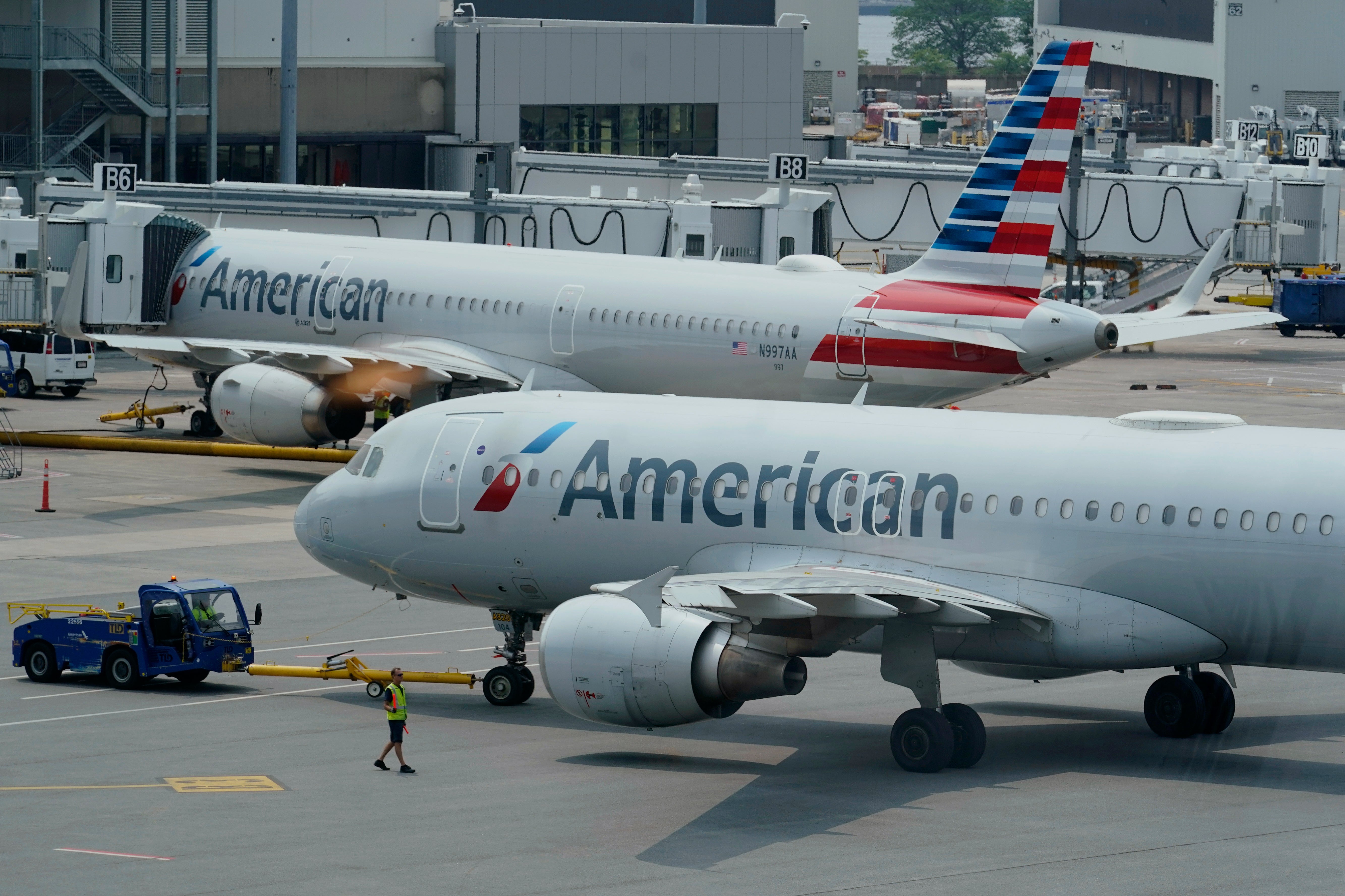 American Airlines passenger jets prepare for departure, Wednesday, July 21, 2021, near a terminal at Boston Logan International Airport, in Boston. (AP Photo/Steven Senne, File)