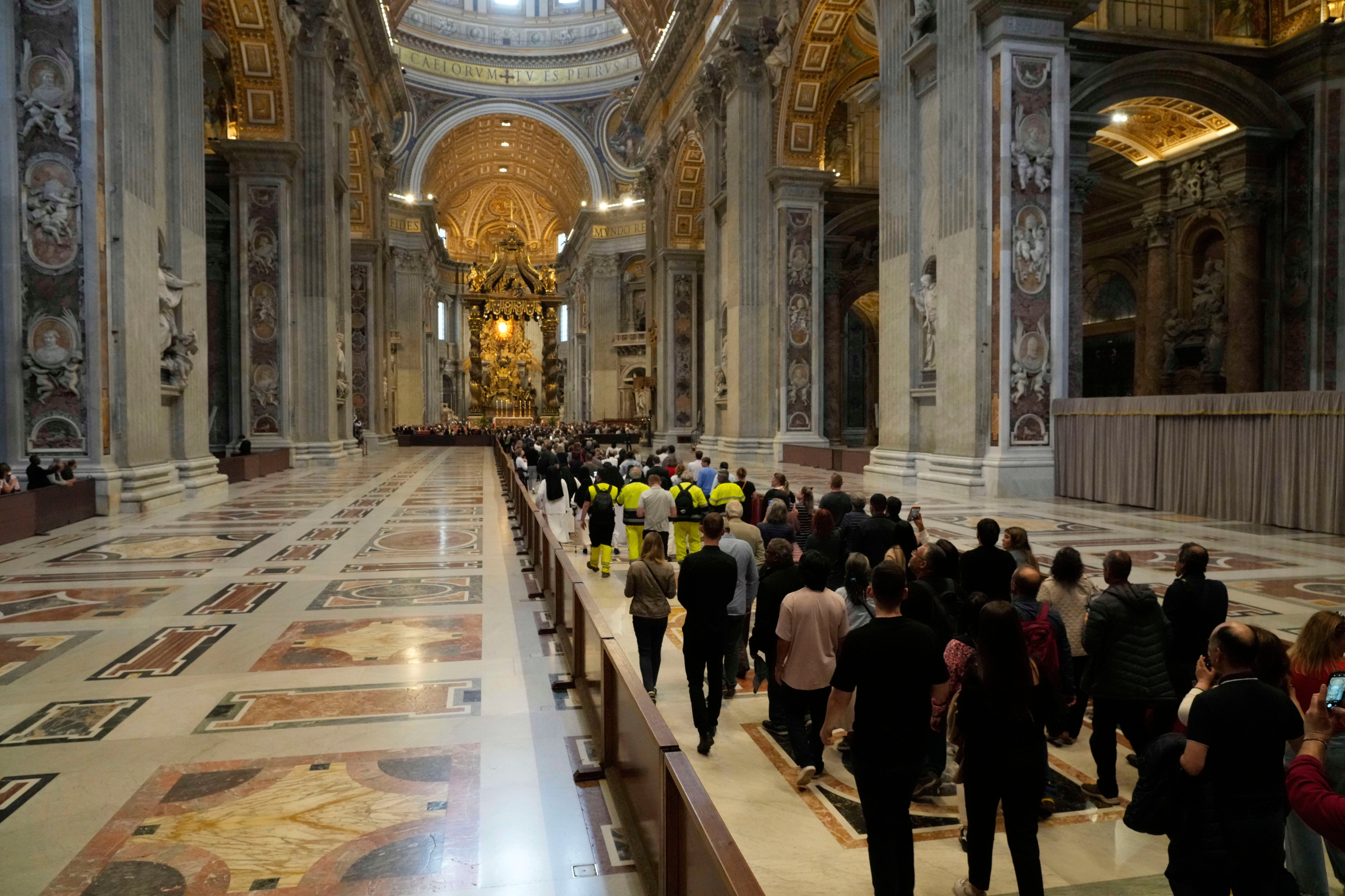 People queue to pay their respects to Pope Francis at the Vatican (Gregorio Borgia/AP)