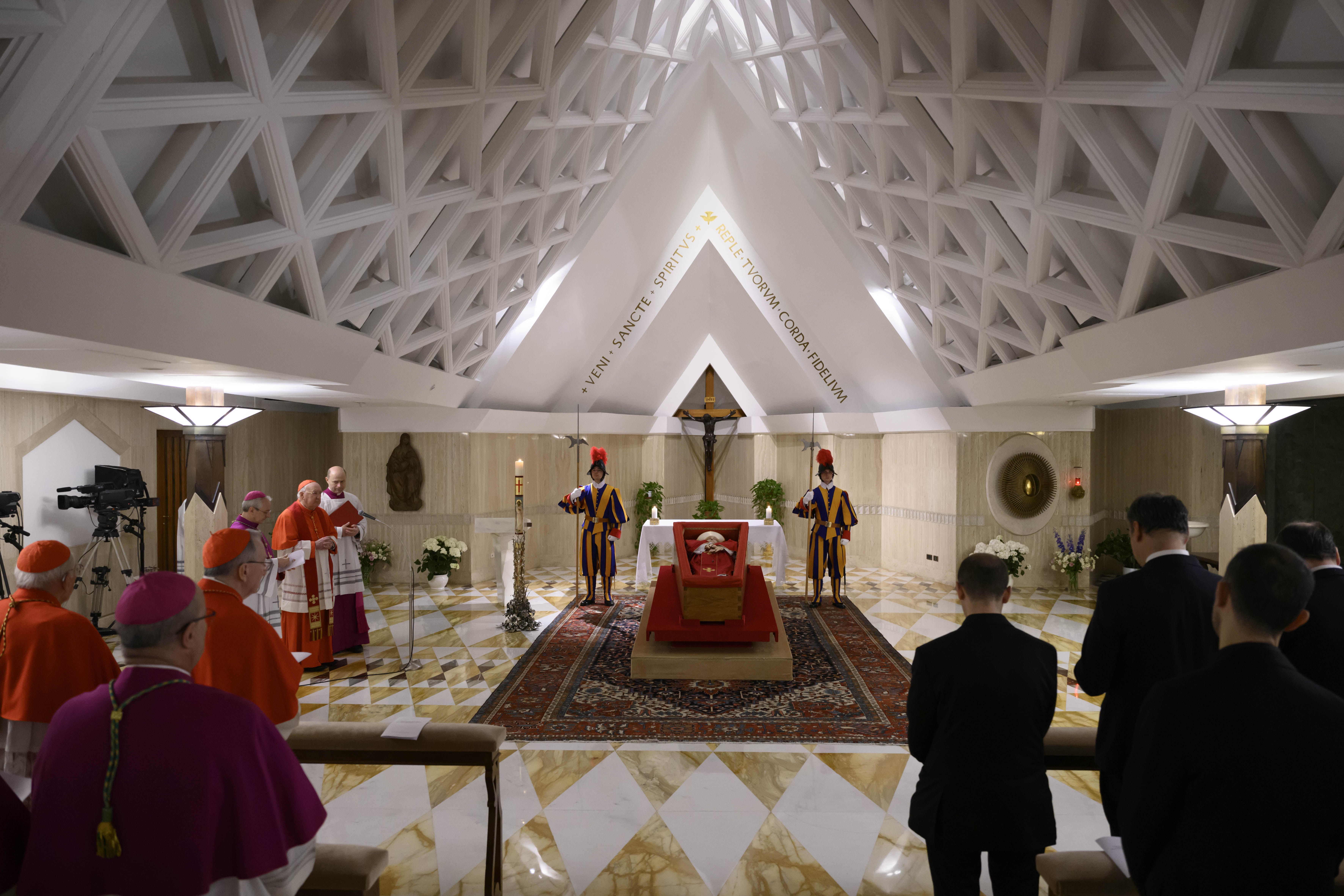 Pope Francis, who died on Easter Monday, lying in a wooden coffin dressed in red, with rosary beads draped across his hands (Vatican Media)