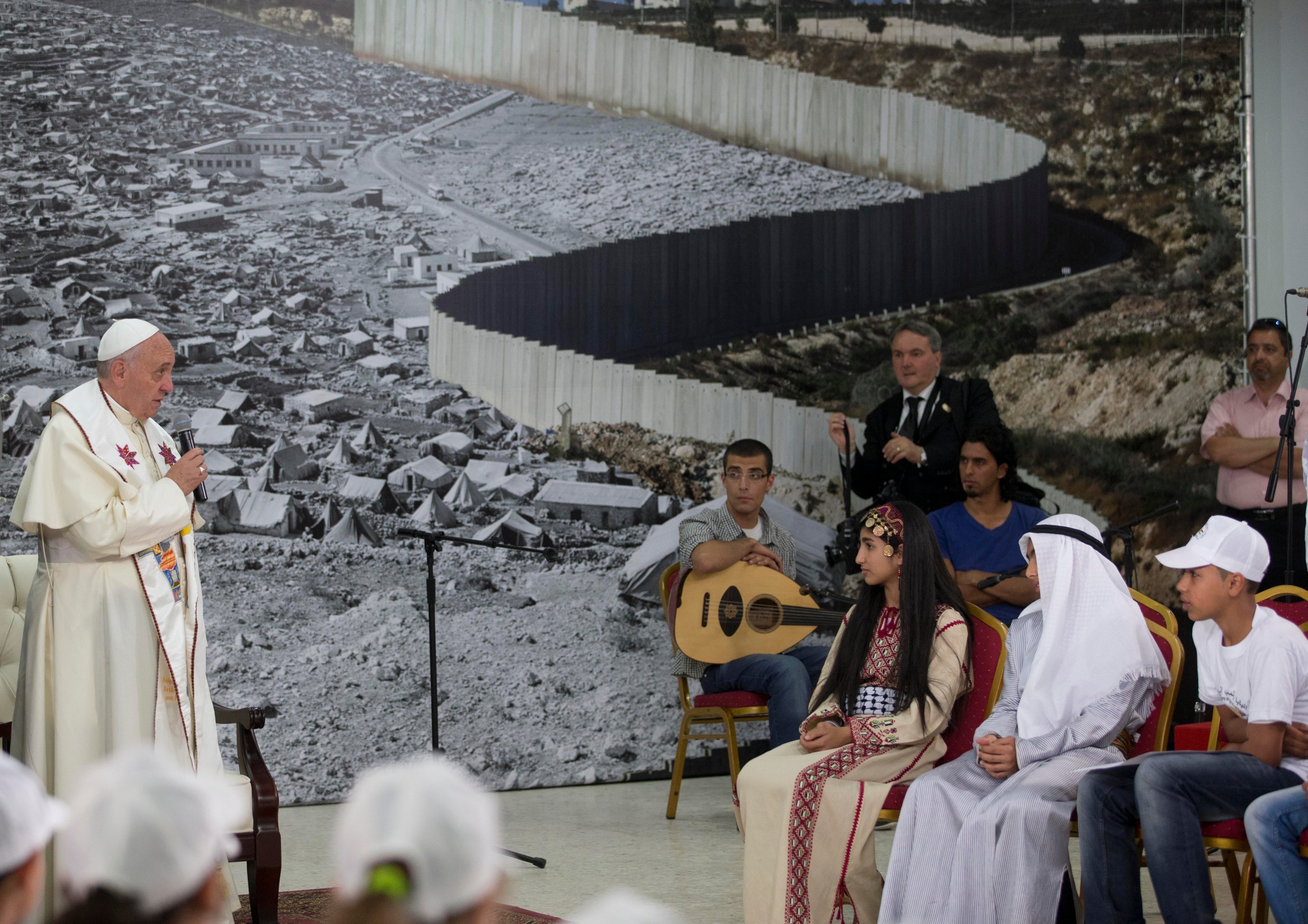 Pope Francis meets children in the Phoenix Center of the Dheisheh refugee camp, near the West Bank town of Bethlehem, Sunday, May 25, 2014