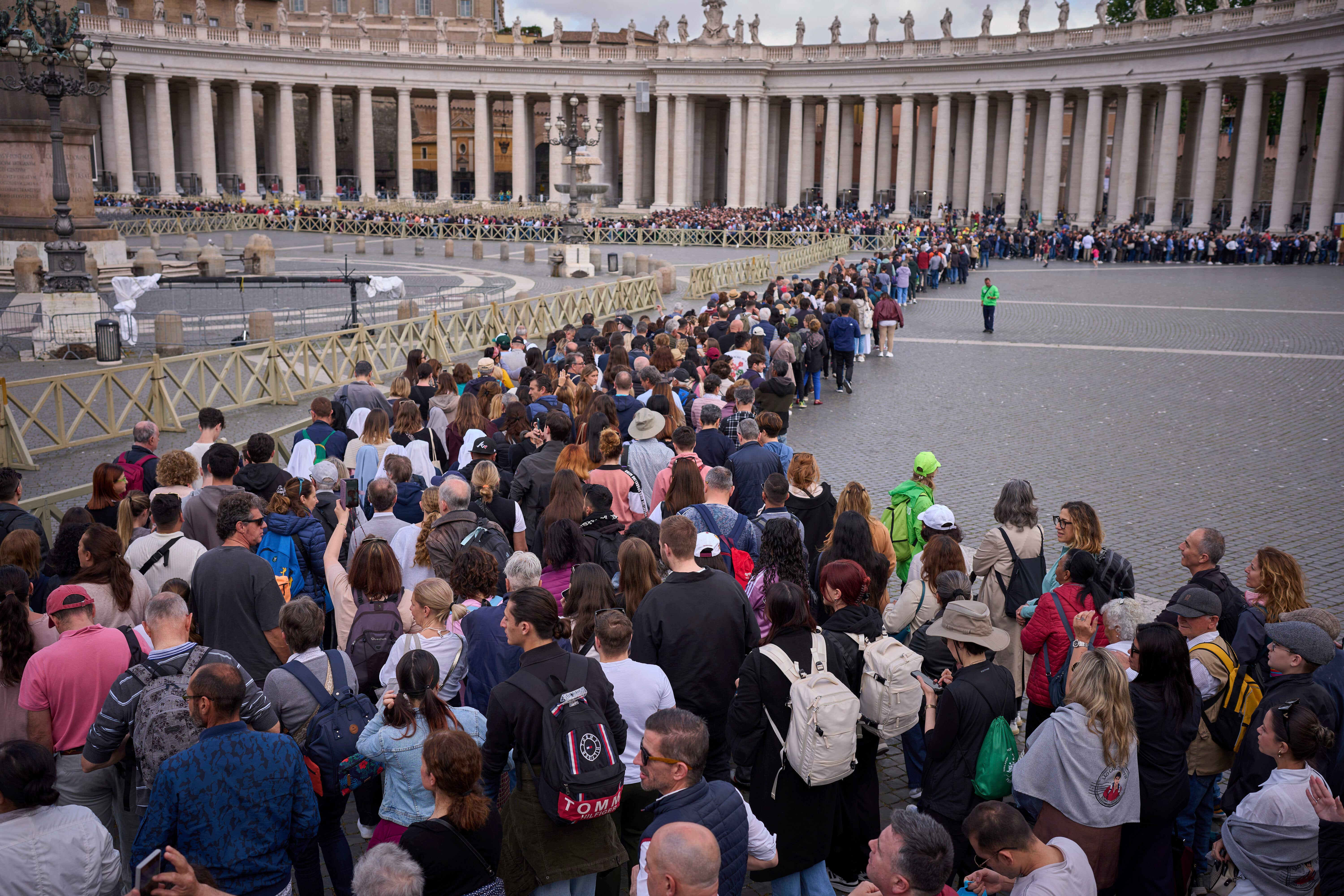 People stand in line as they wait to enter St Peter’s Basilica to pay their respects to Pope Francis (Emilio Morenatti/AP)