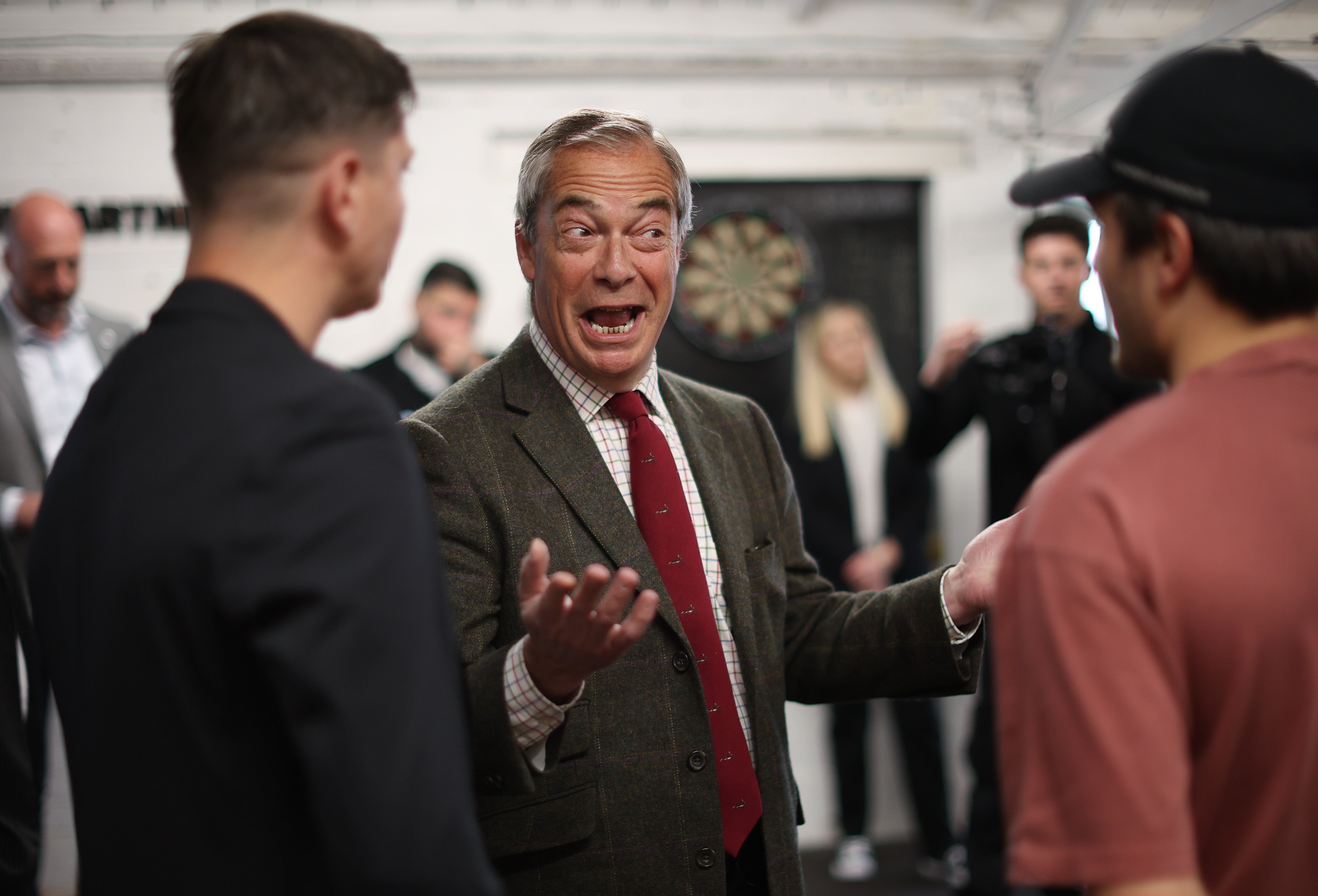 Leader of Reform UK party Nigel Farage talks to boxers at the Boxclub gym in Hull, Britain, 25 April 2025