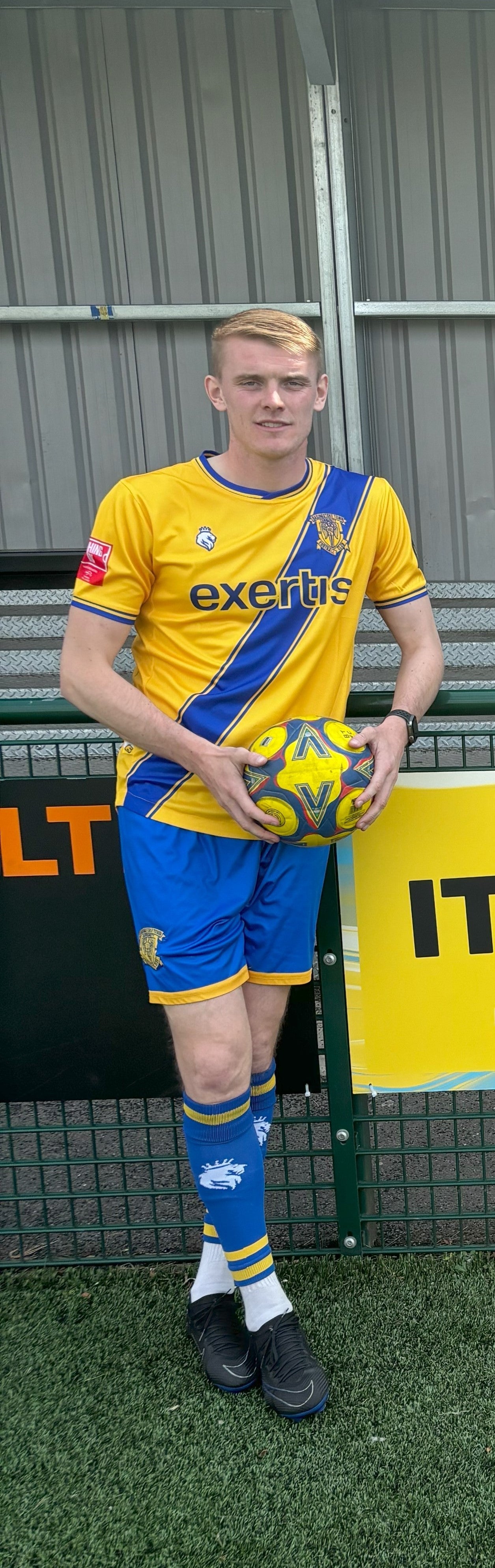 Footballer Ben Cook wearing a Basingstoke Town football club kit whose match shirts have been redesigned to feature a seat belt motif as part of a road safety campaign backed by former England striker Ian Wright