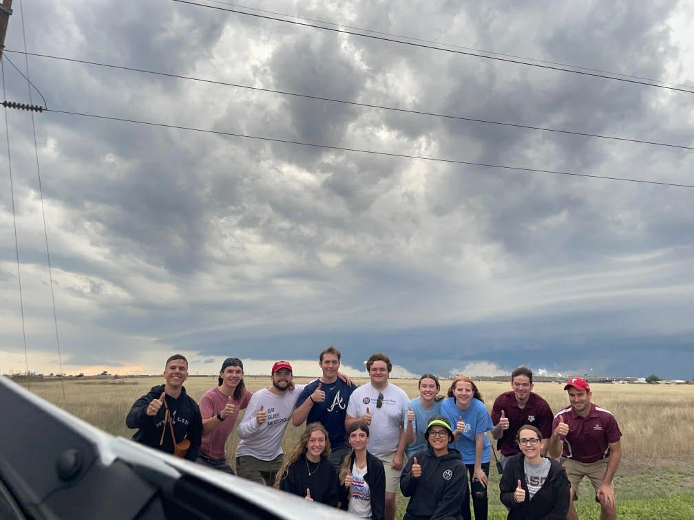 Dr. Chris Nowotarski poses with his students out in the field. He noted that have the right data is critical to be able to predict tornados and their formation.
