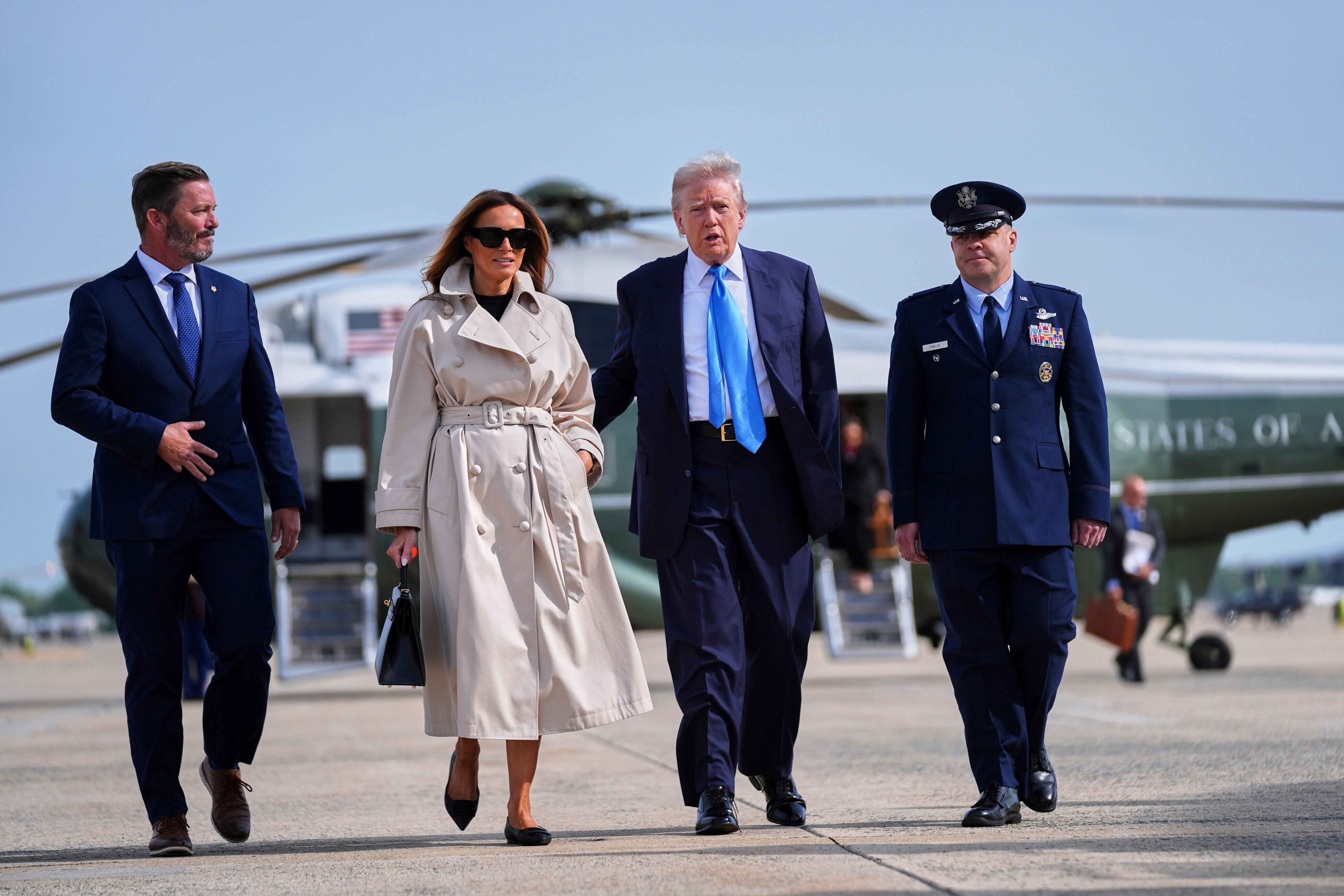 President Donald Trump walks with First Lady Melania Trump. The president suggested he’s been too ‘busy’ with tariffs to buy her a gift