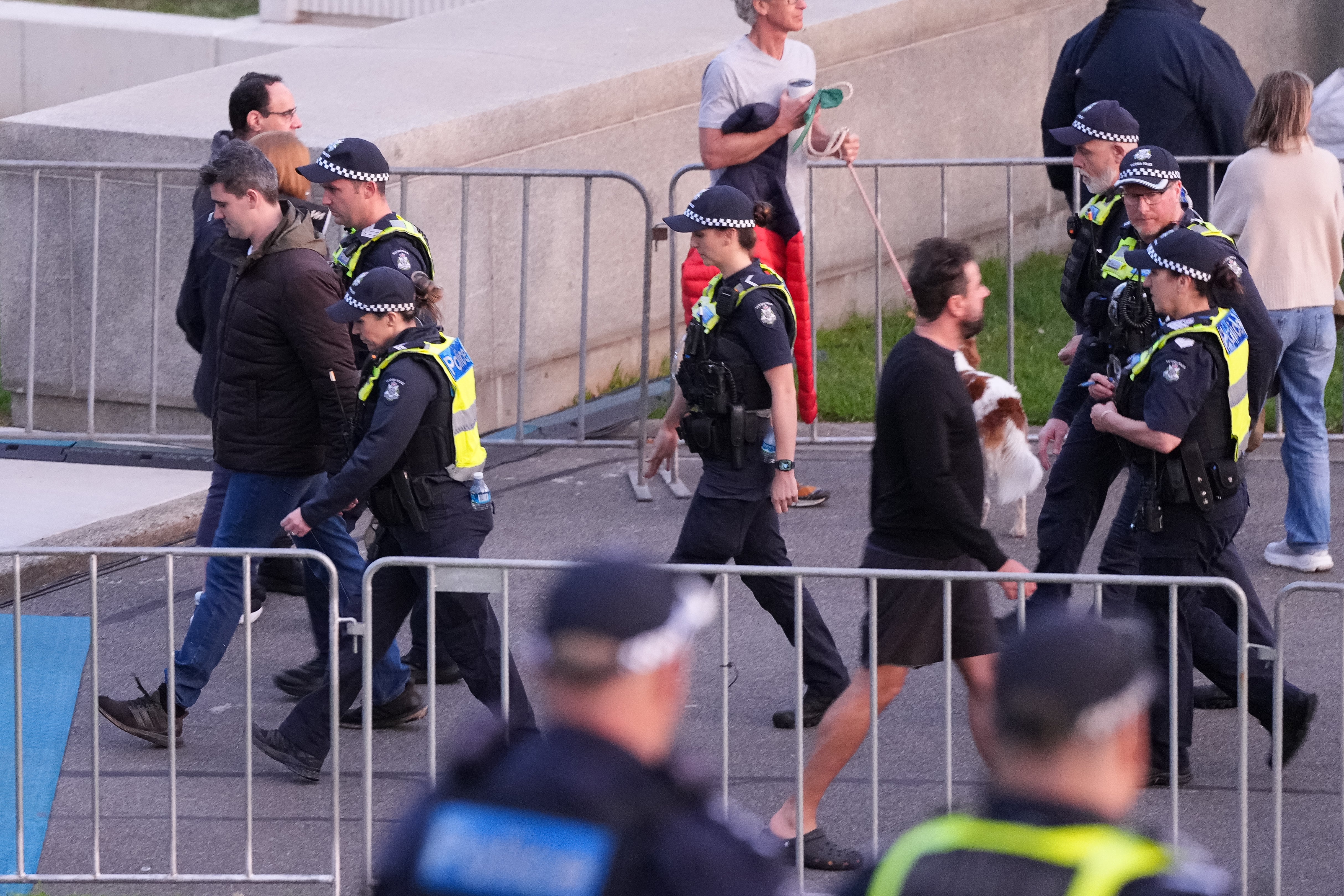 A man is escorted by police during the dawn service at the Shrine of Remembrance