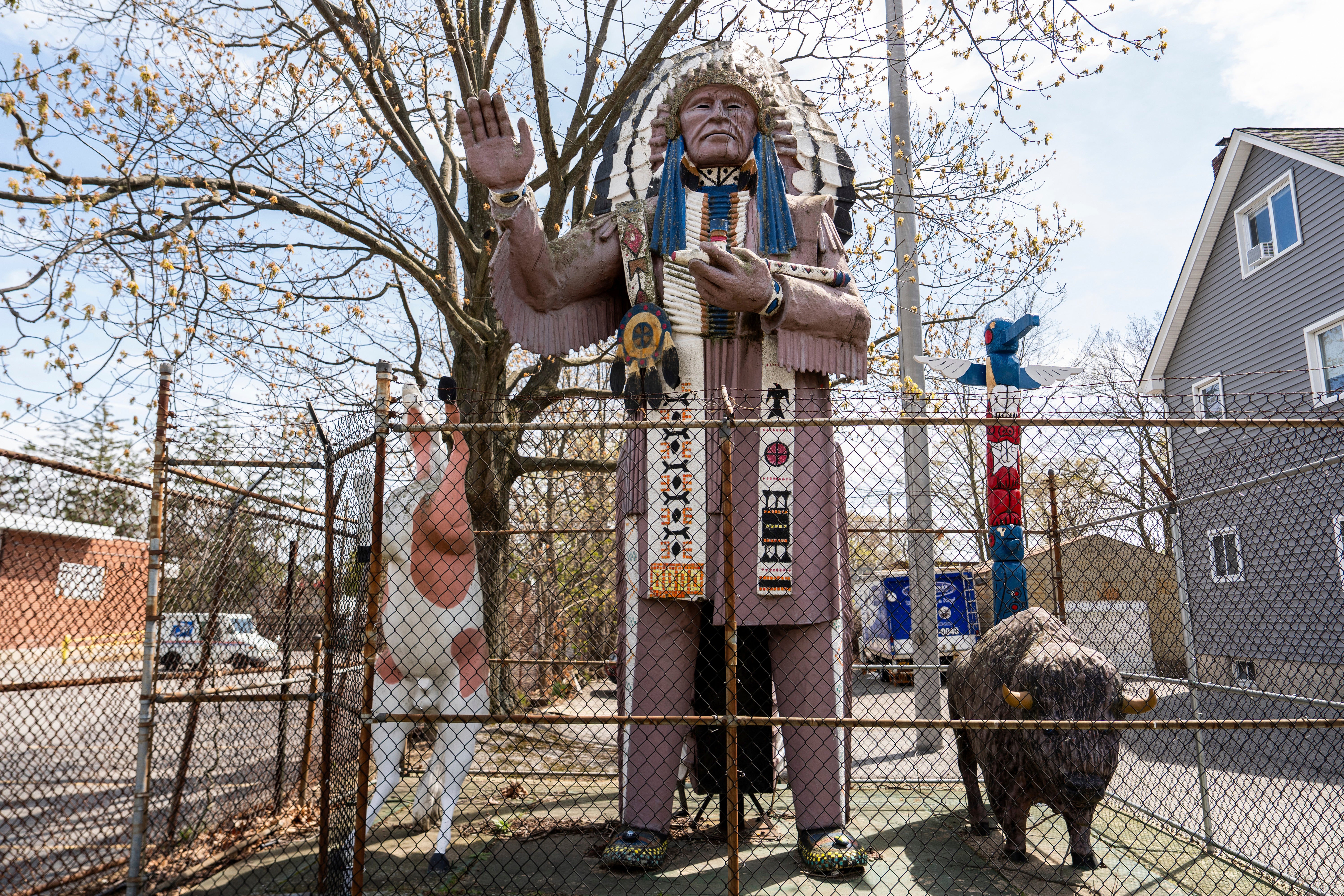 A Big Chief Lewis statue is surrounded by a fence in Massapequa, N.Y., Friday, April 25, 2025. (AP Photo/Julia Demaree Nikhinson)