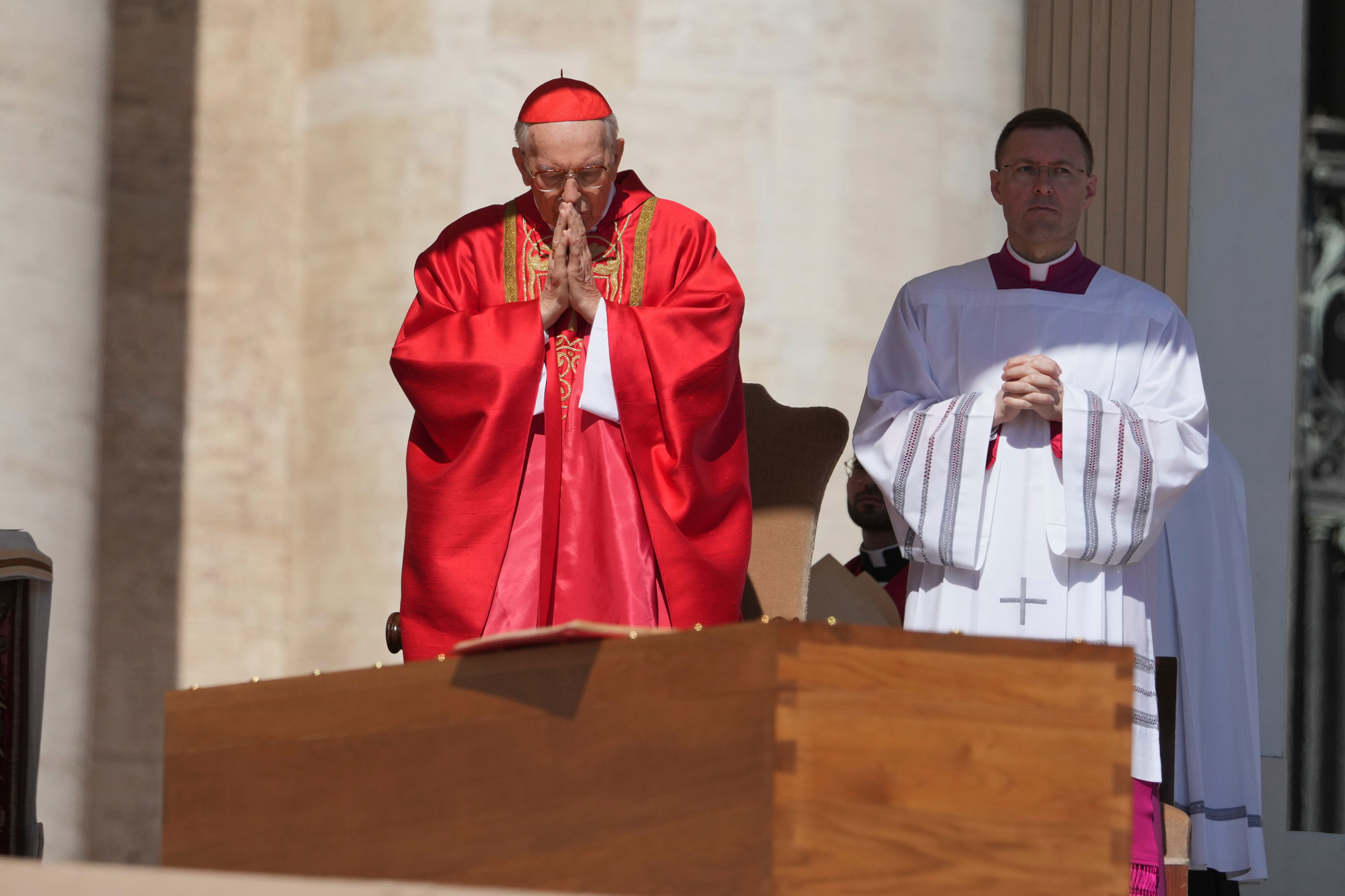 Dean of the College of Cardinals Giovanni Battista Re prays in front of the coffin (Alessandra Tarantino/AP)