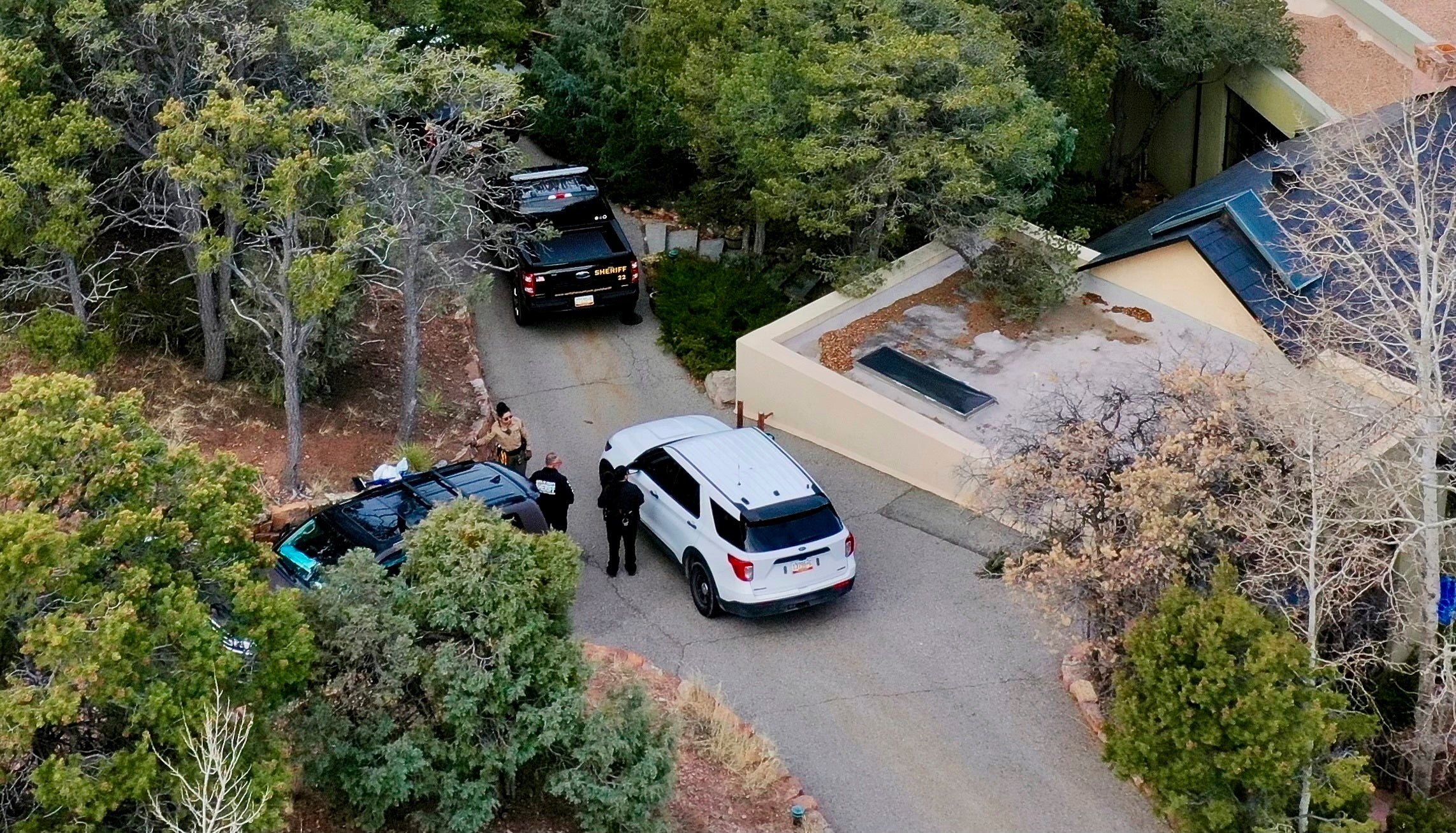 Law enforcement officials talk outside the home of actor Gene Hackman on Thursday, Feb. 27, 2025, in Santa Fe, New Mexico. The home was in disarray, with rat infestations throughout the estate