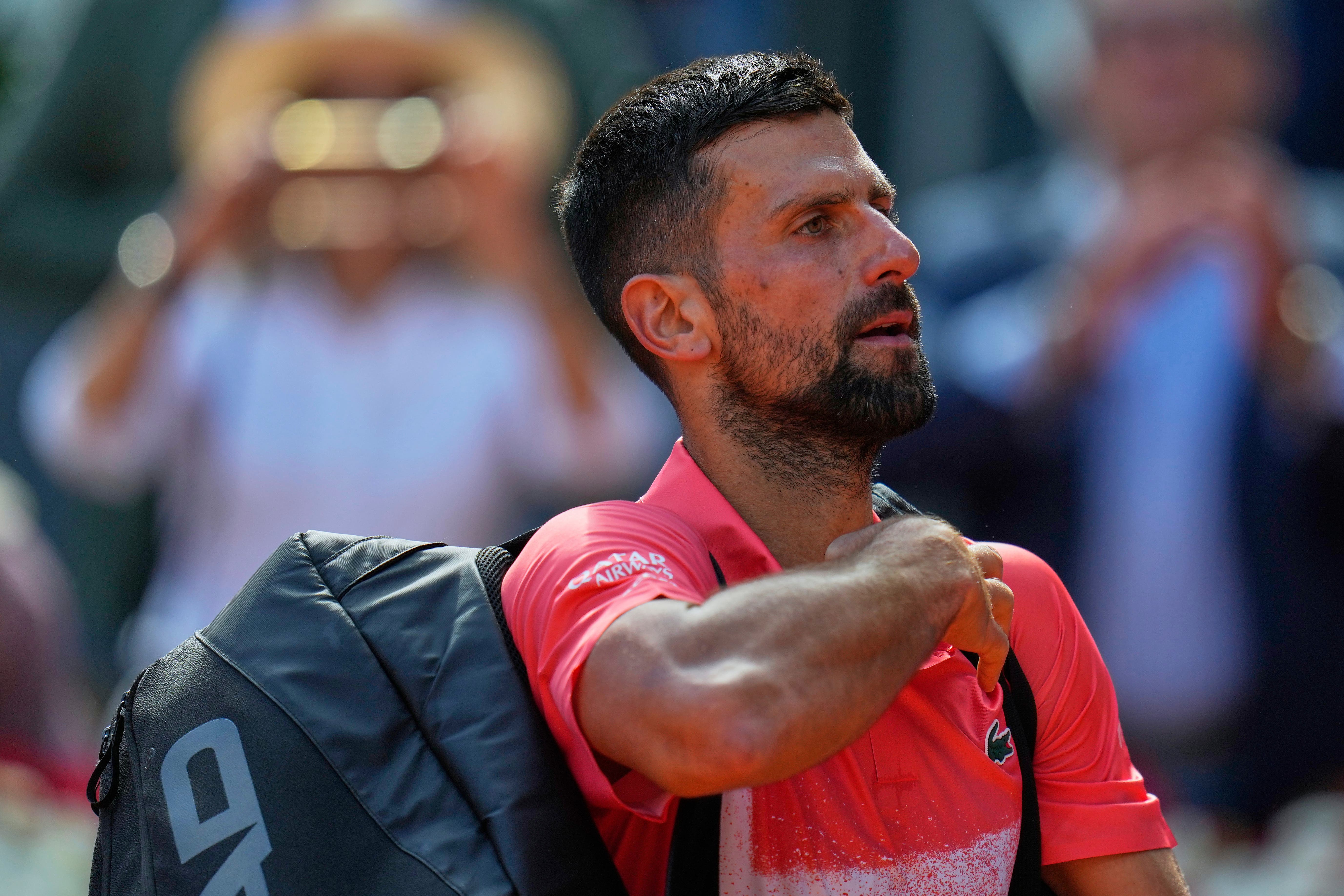Novak Djokovic leaves the court after losing to Matteo Arnaldi (Manu Fernandez/AP)