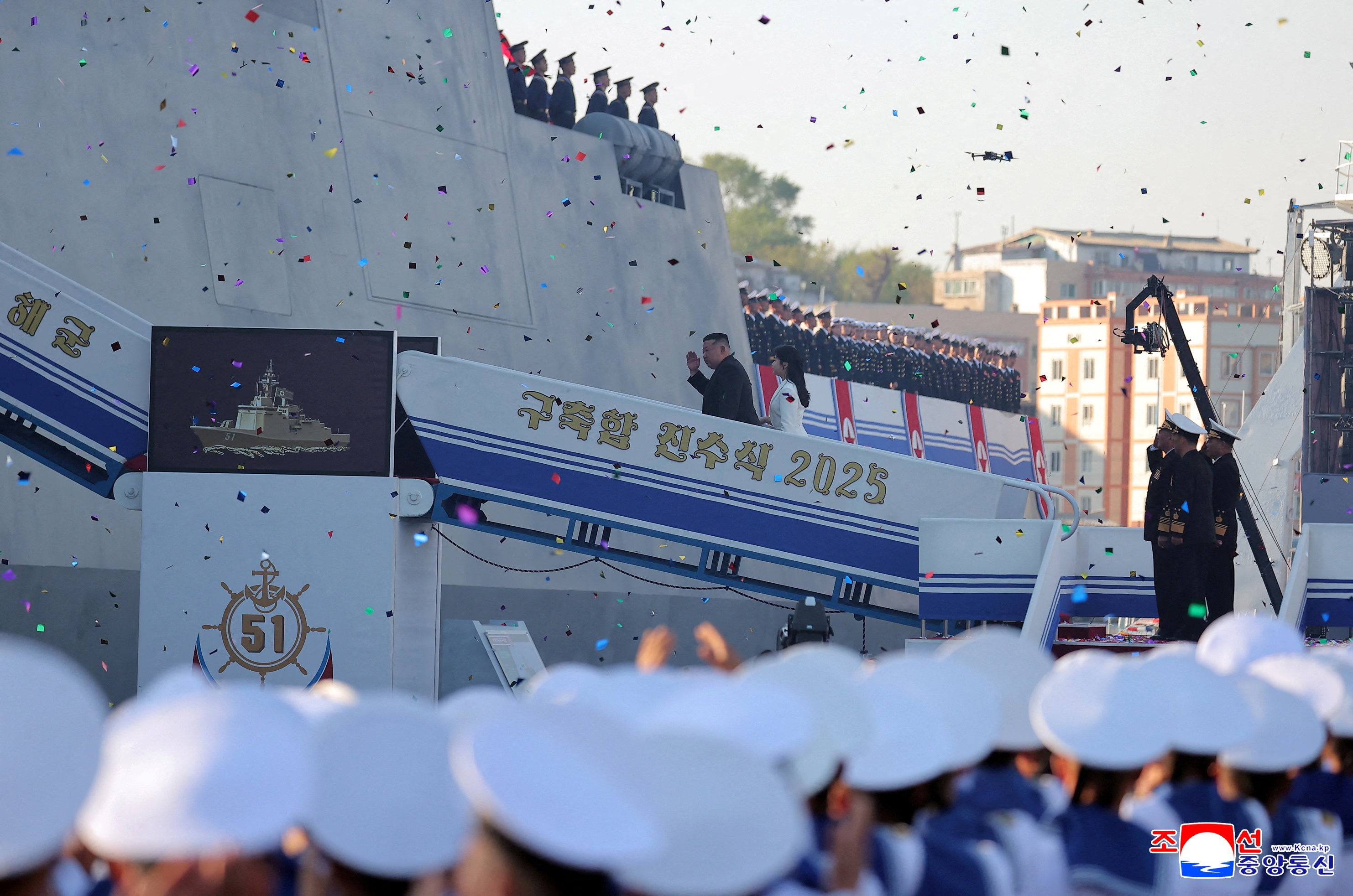 North Korean leader Kim Jong Un, accompanied by his daughter Kim Ju Ae, attends a ceremony for the launch of a "new multipurpose destroyer,"