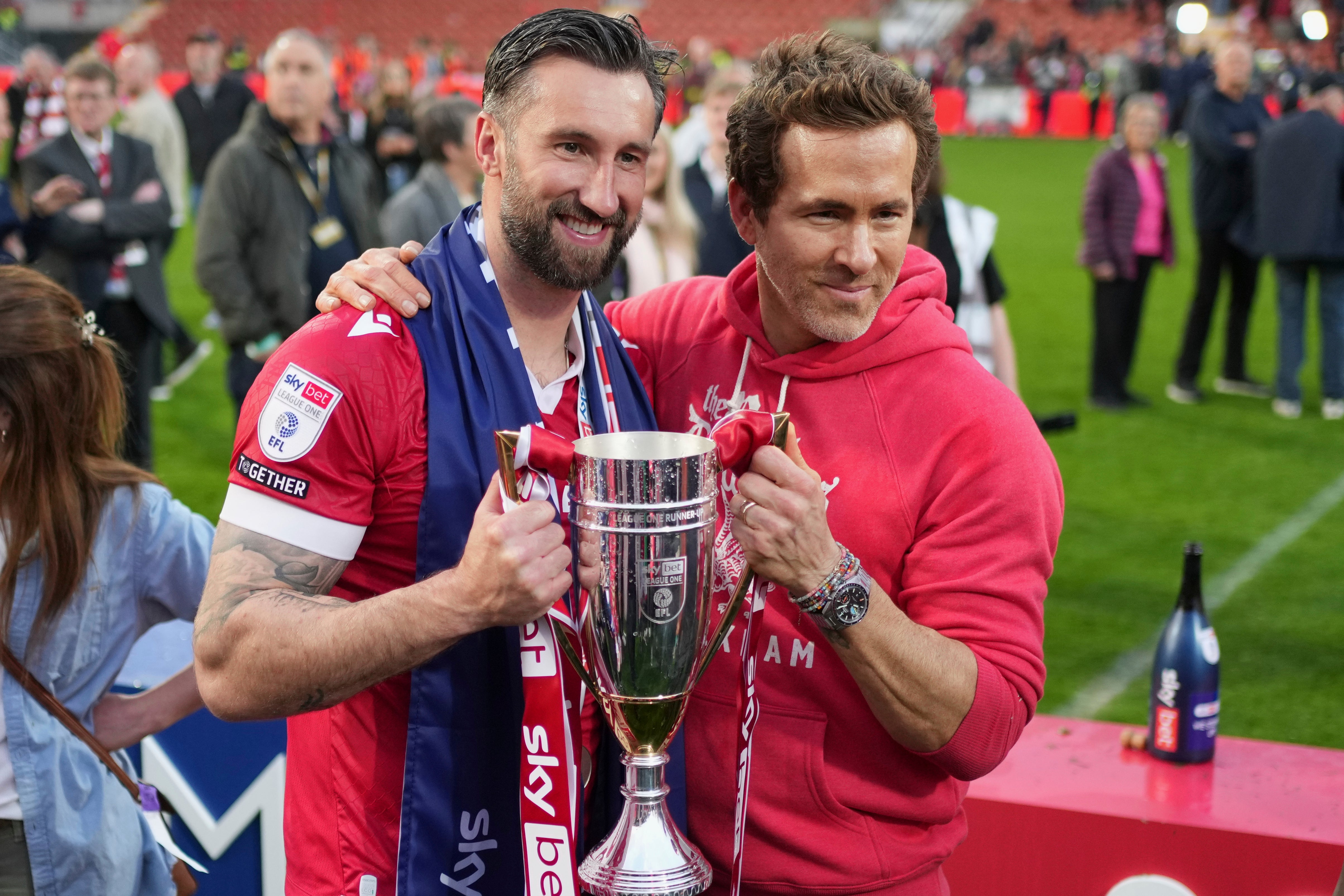 Wrexham co-owner Ryan Reynolds, right, and Wrexham's Ollie Palmer pose with trophy at the Racecourse ground in Wrexham, Wales