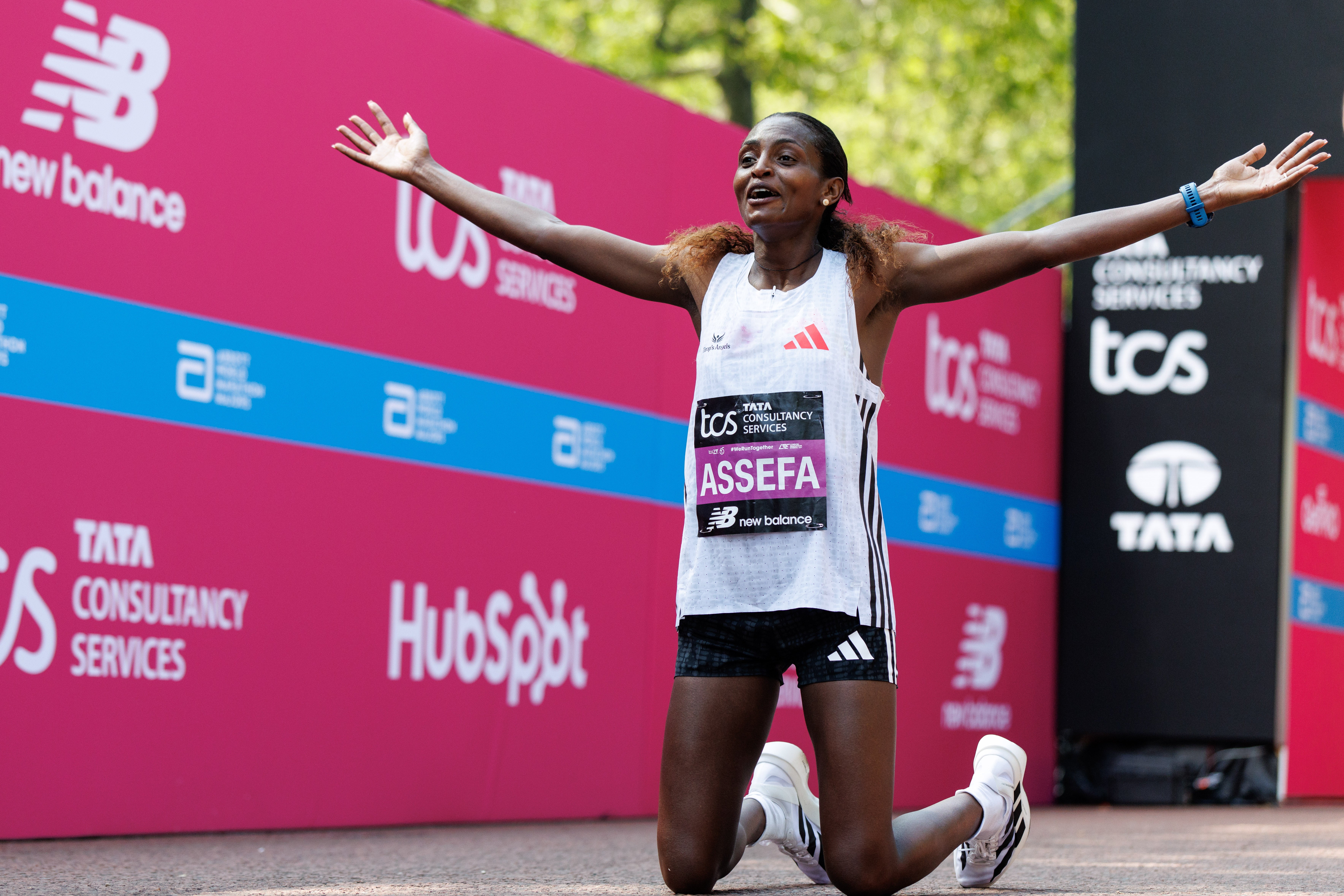Ethiopia's Tigst Assefa reacts to finishing first in the women's race of the London Marathon and breaking the women's-only world record
