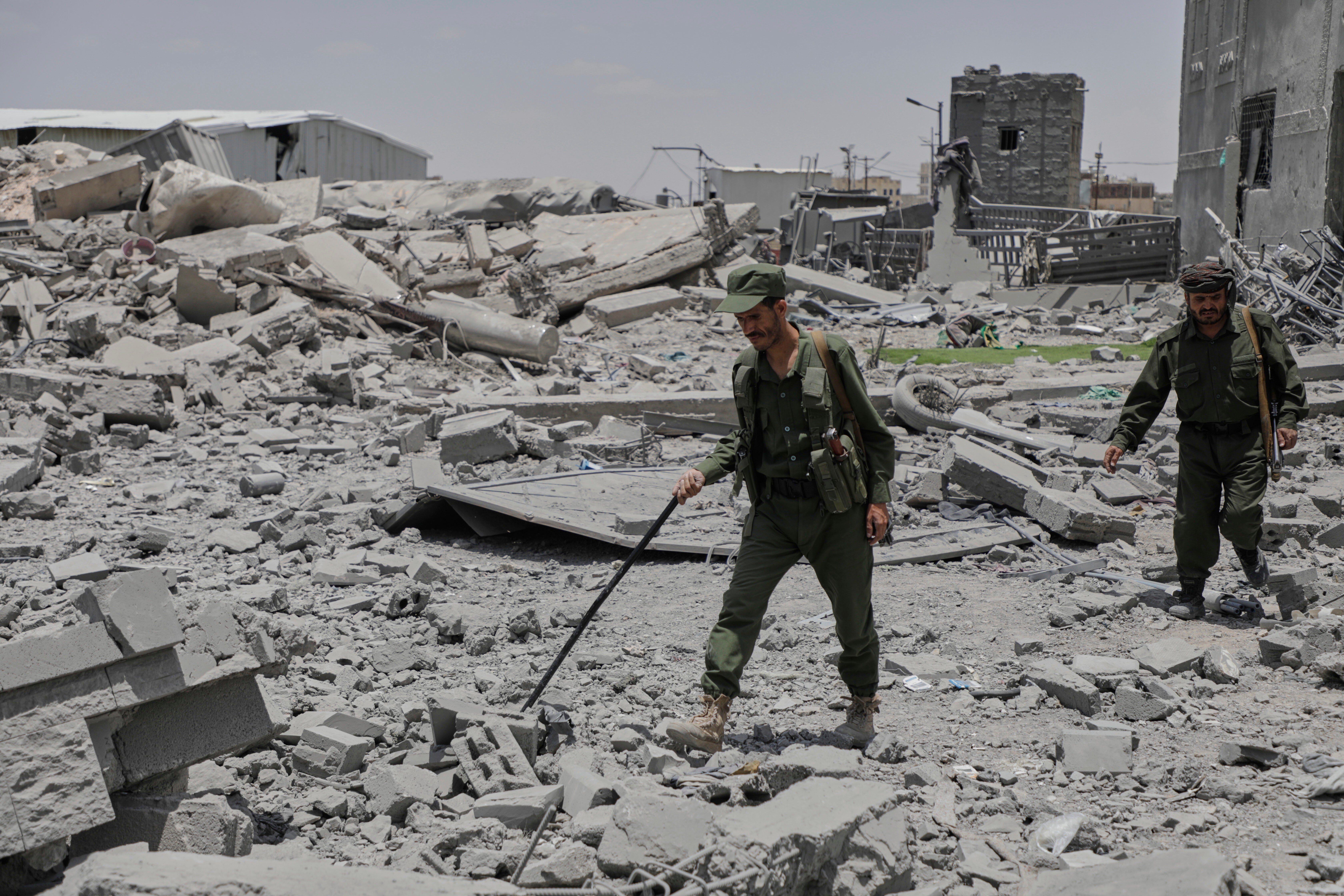 Yemeni soldiers inspect the damage reportedly caused by U.S. airstrikes in Sanaa, Yemen, Sunday, April 27, 2025. (AP Photo/Osamah Abdulrahman)