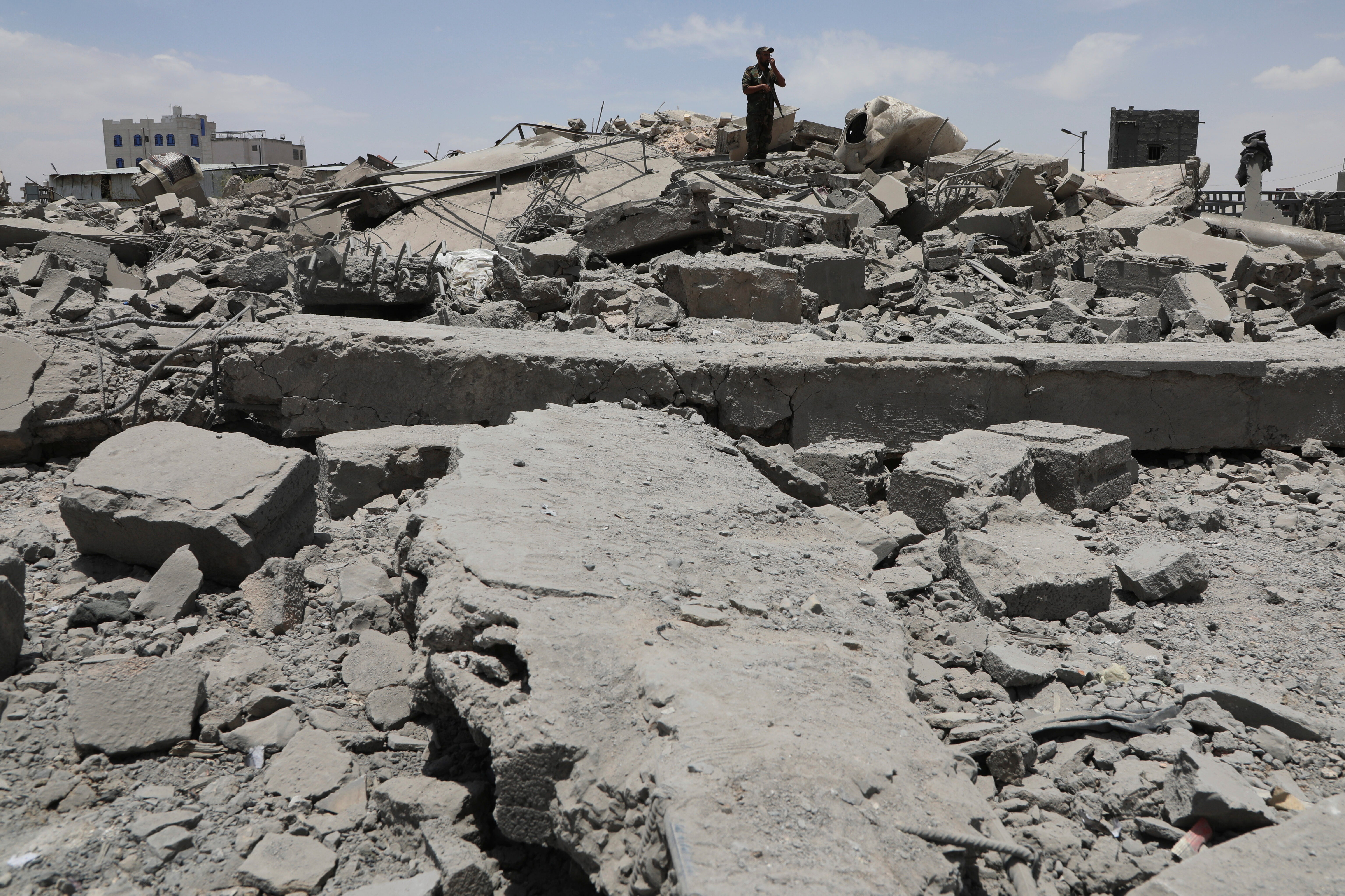 A Yemeni soldier inspects the damage reportedly left by a US air strike