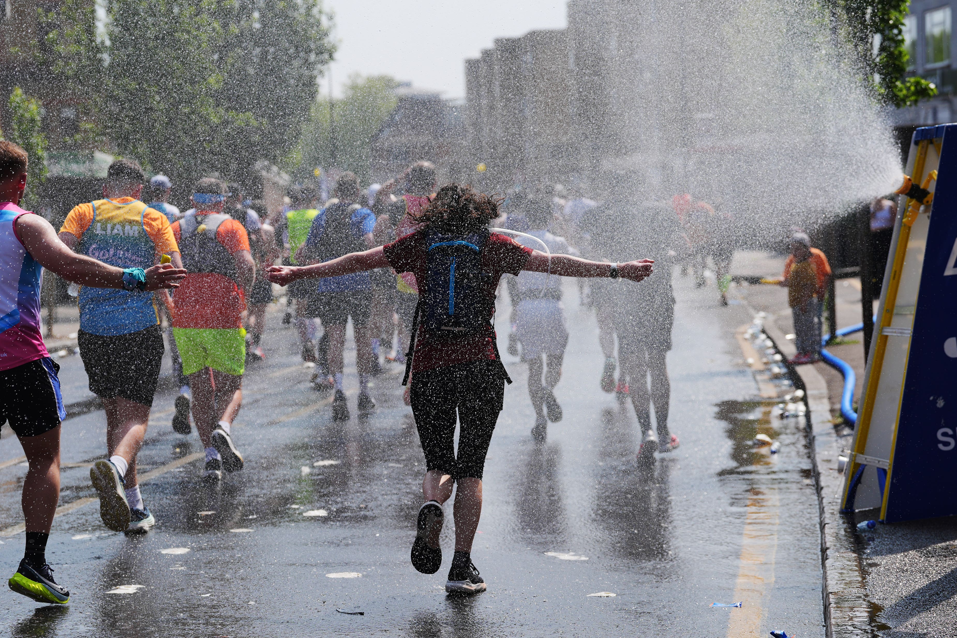Runners are sprayed with water during the TCS London Marathon (Yui Mok/PA)