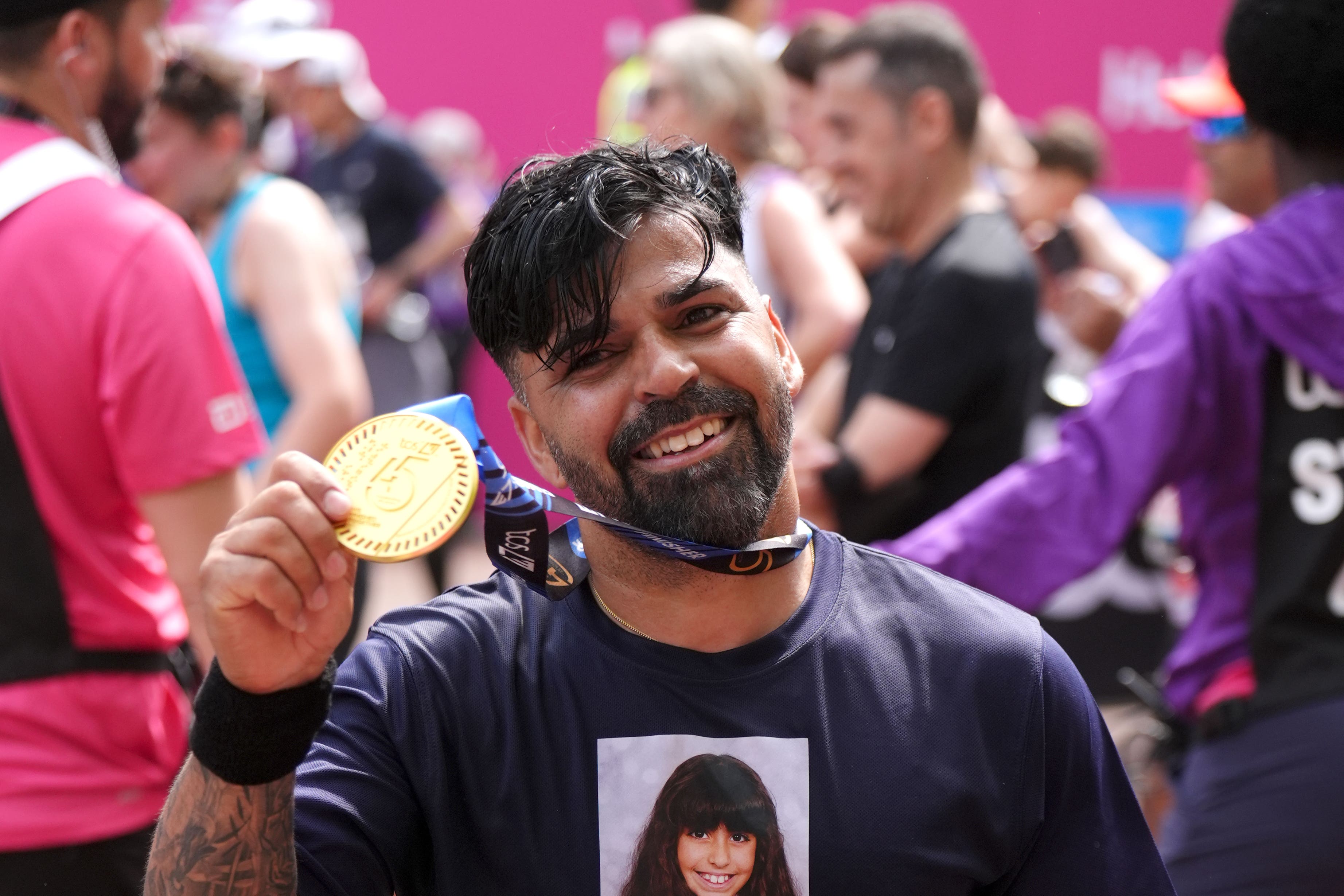Sergio Aguiar, the father of Southport attack victim Alice, running for Churchtown Primary School after crossing the finish line during the TCS London Marathon (John Walton/PA)