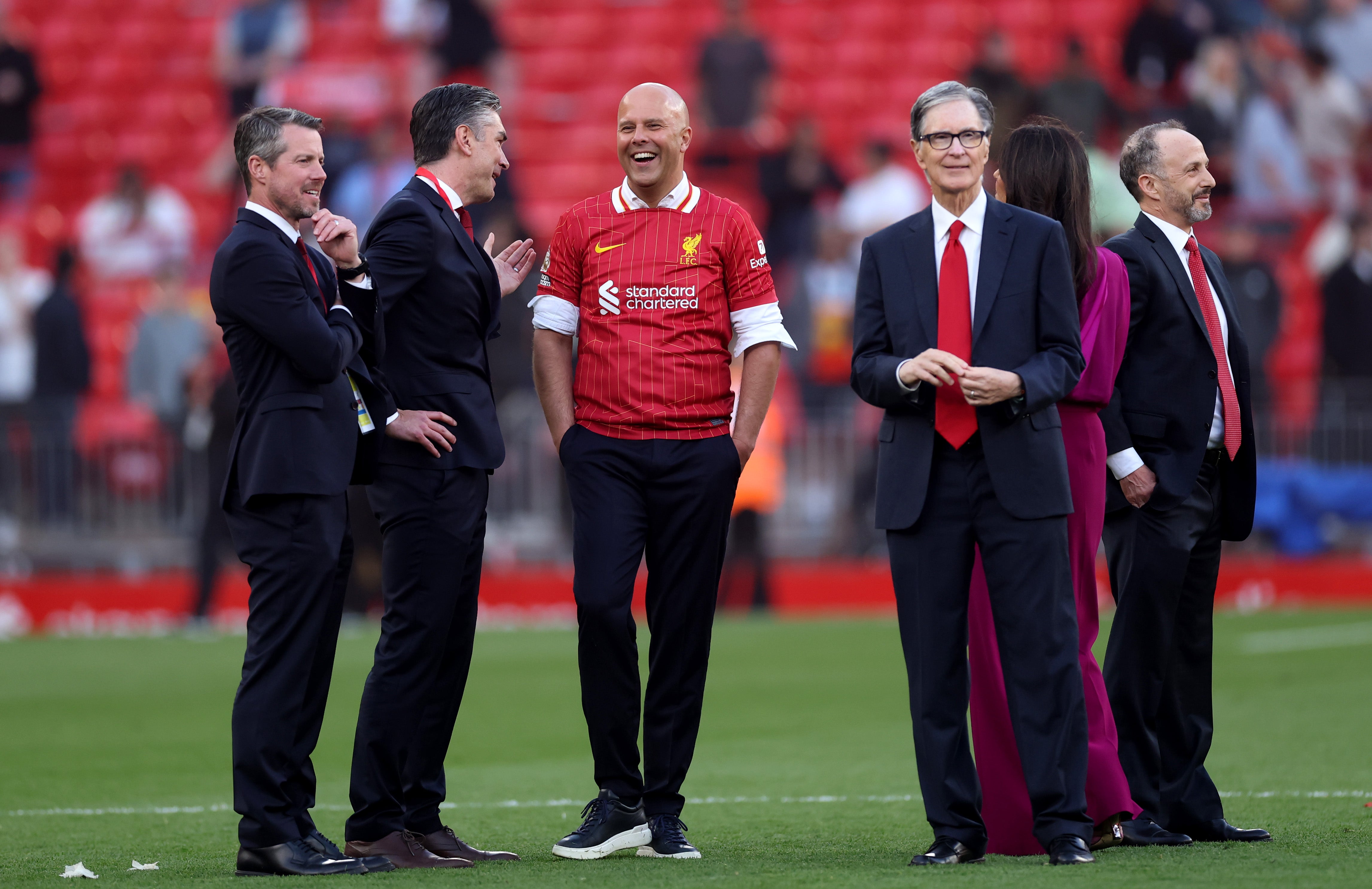 Slot was congratulated by owner John W Henry (right) after the game