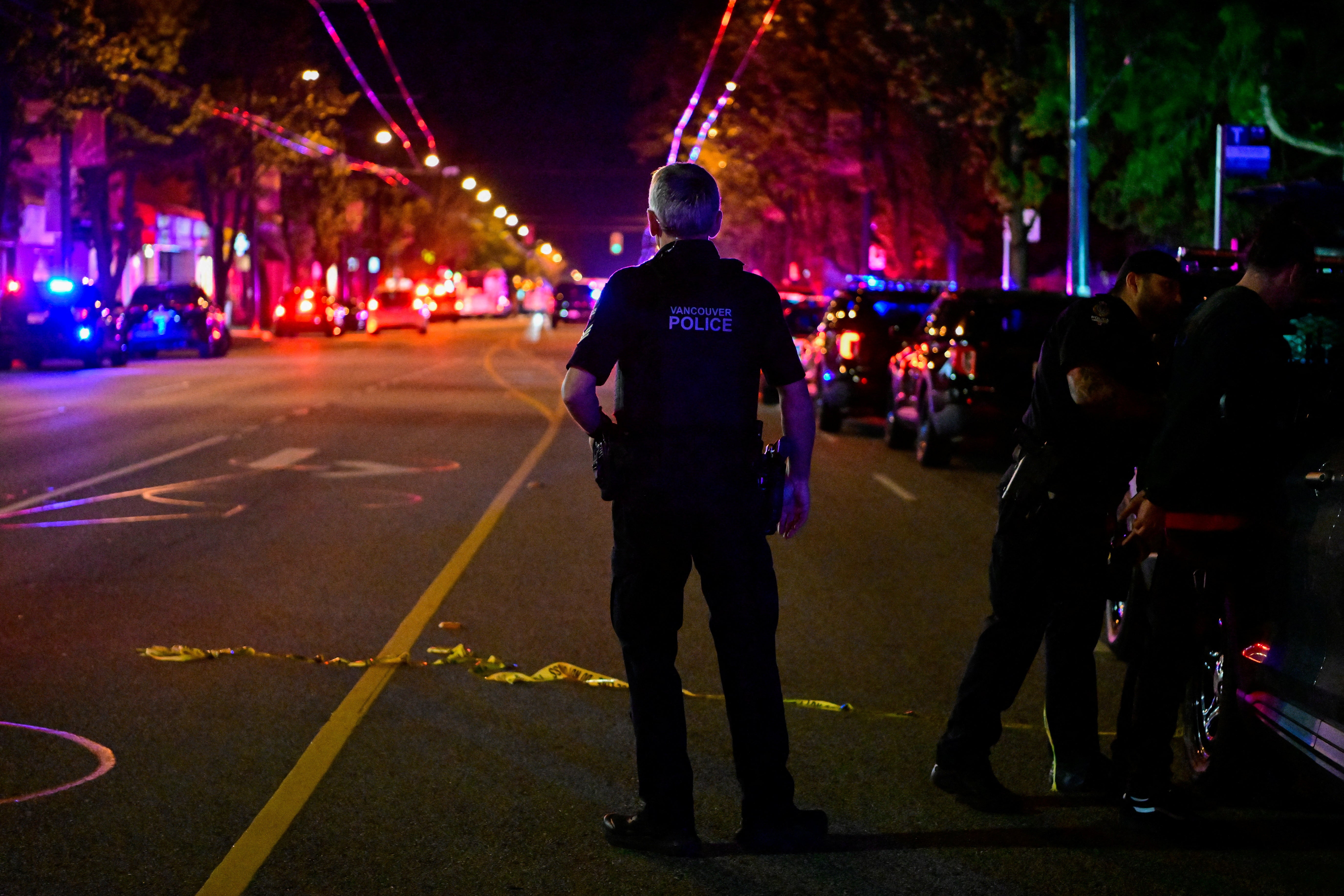 Police work on Fraser street, near the site of the Lapu Lapu day block party where a vehicle drove into a crowd killing several people