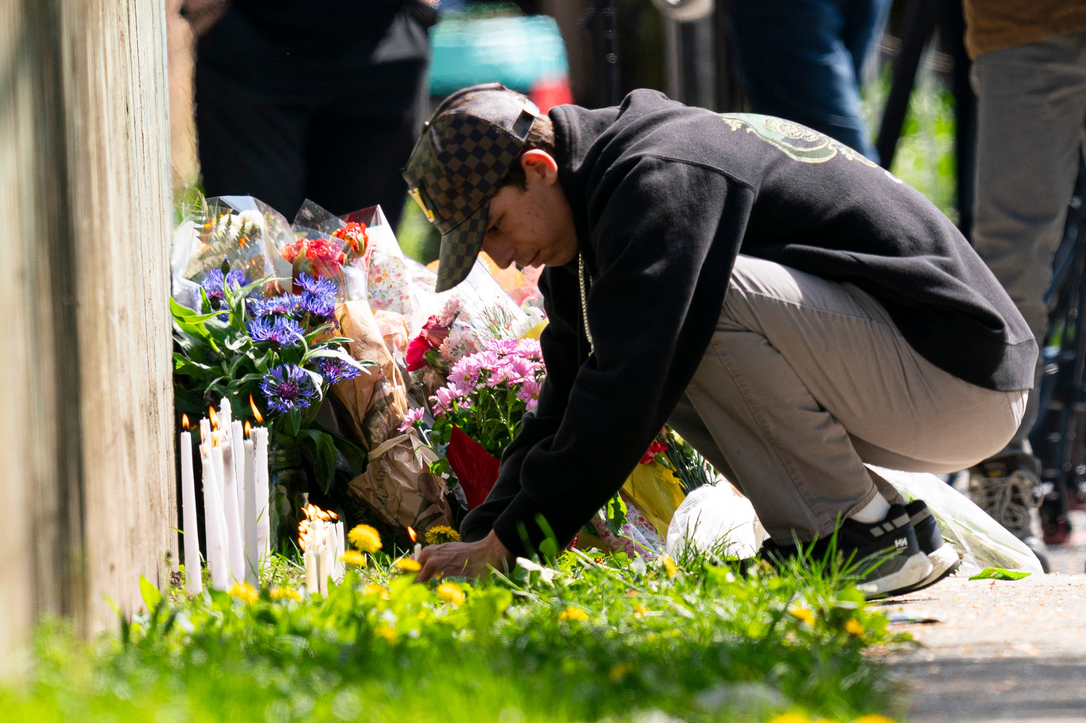 A member of the public lights a candle near the scene where a vehicle drove into crowd on Saturday