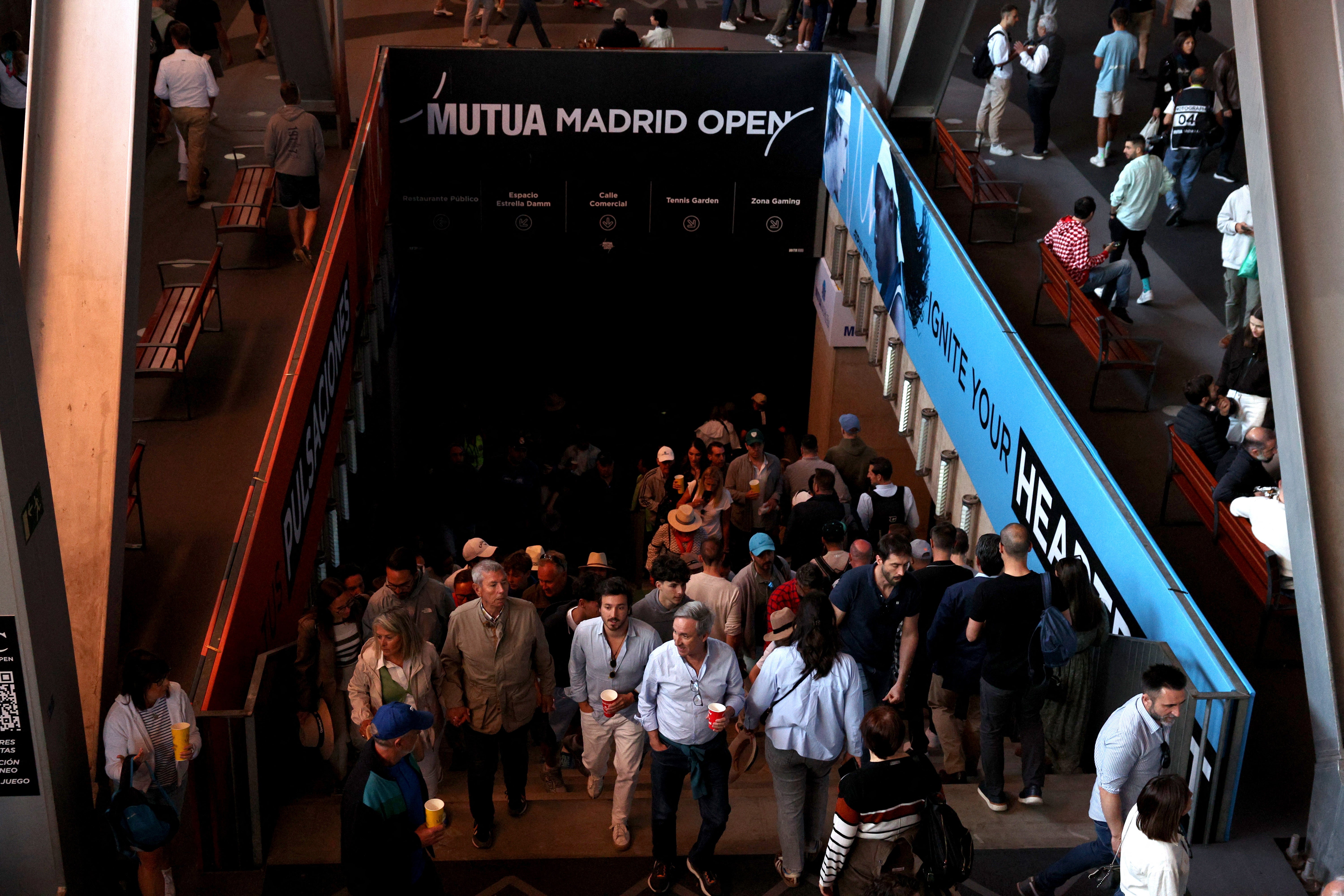 Fans at the Madrid Open leave a stadium after matches were suspended due to a power outage