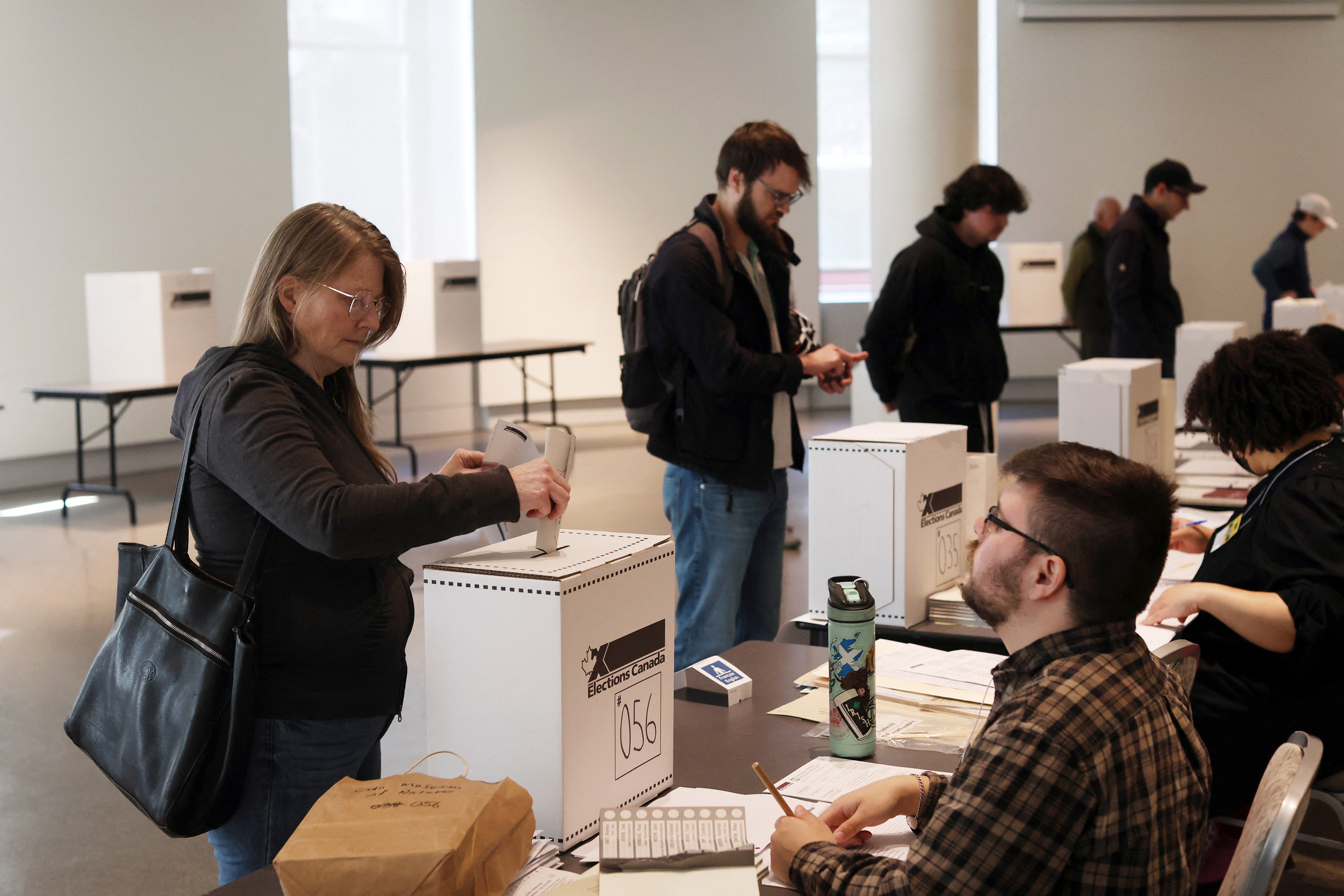 A voter casts her ballot at a polling station on election day, on April 28, 2025 in Ottawa, Canada