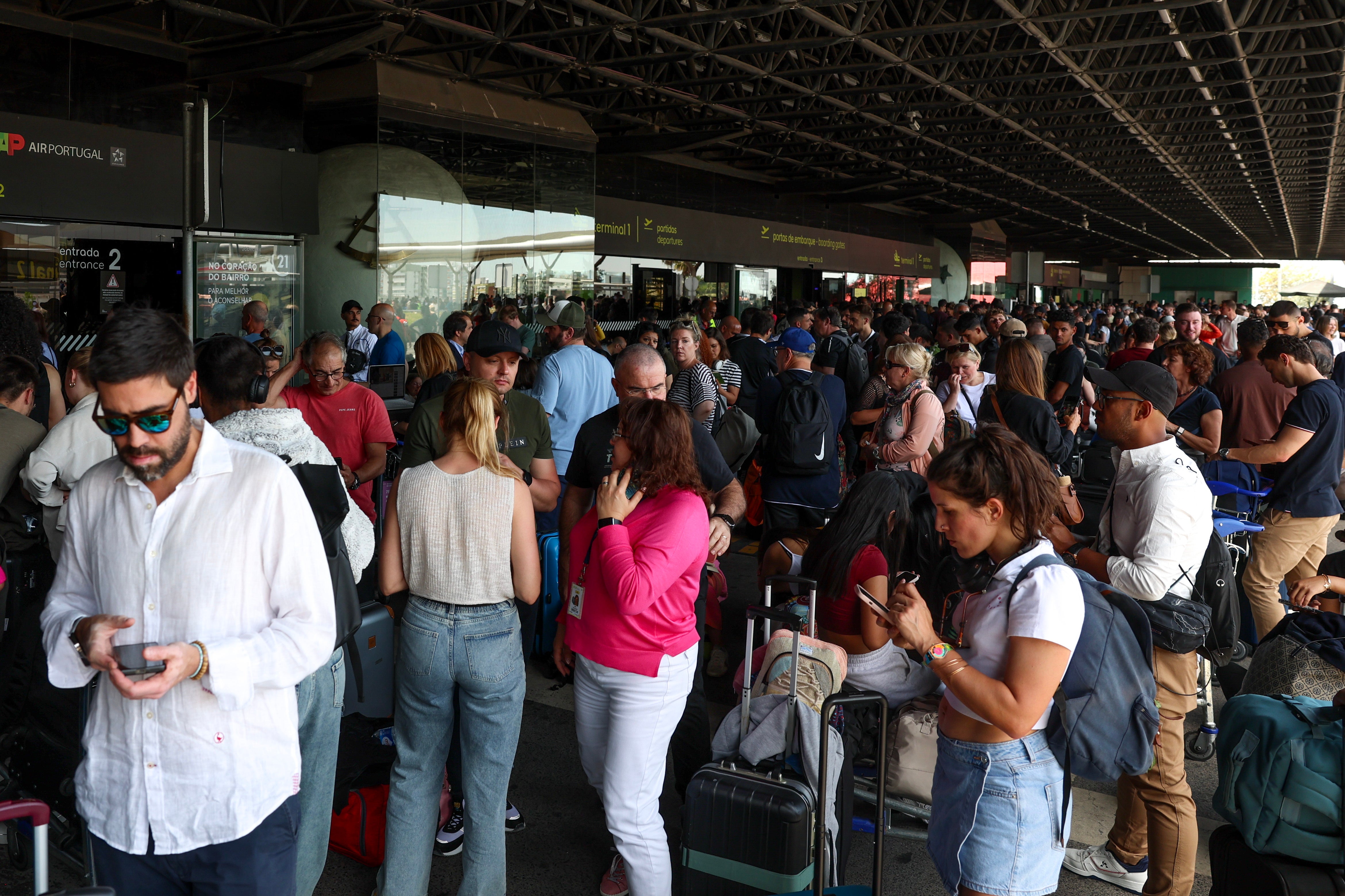 Commuters wait at the entrance of departures at Lisbon's Humberto Delgado airport as the area is closed due to the blackout affecting Spain and Portugal, in Lisbon, Portugal, 28 April 2025.
