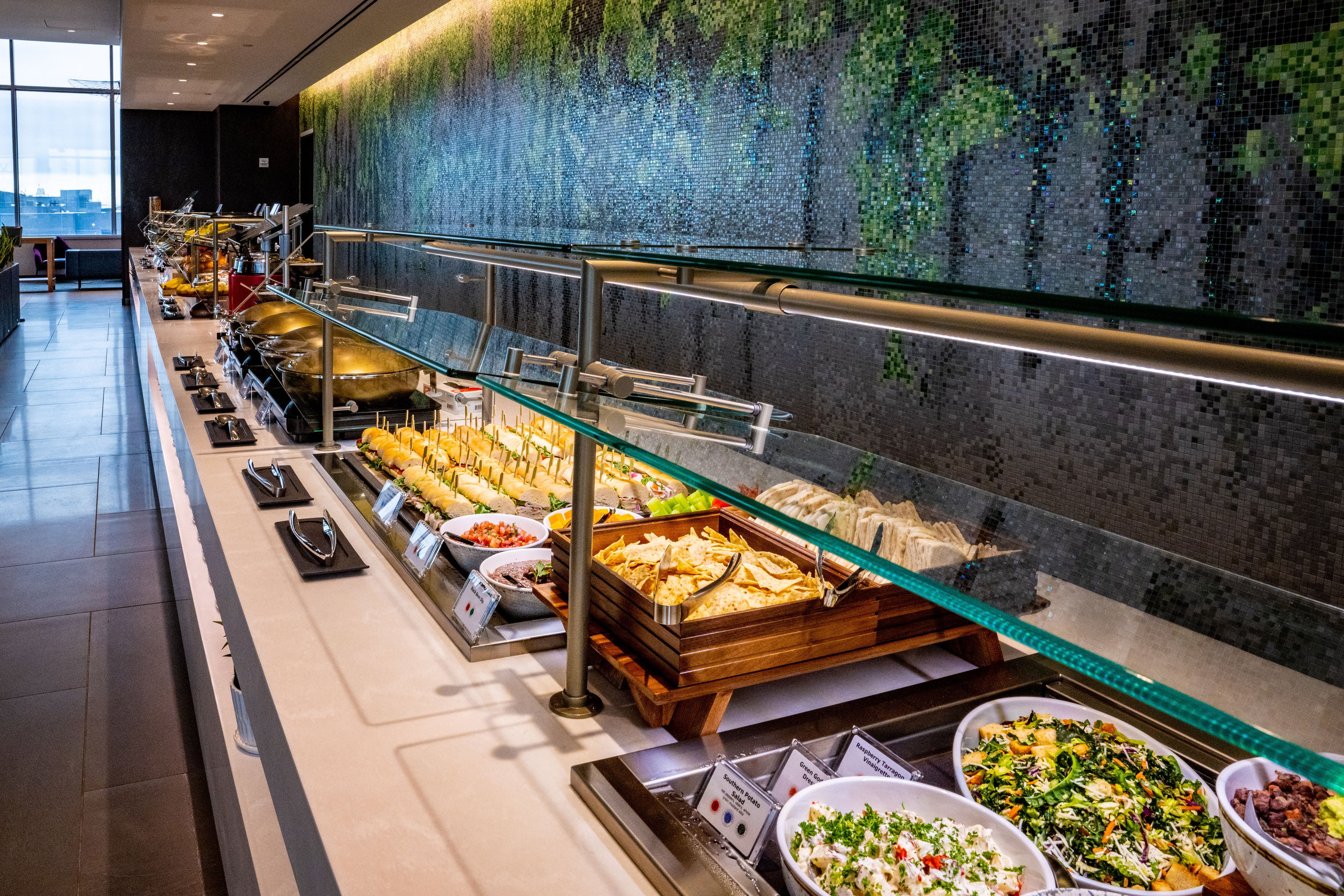 The space is equipped with a large food buffet and two beverage stations