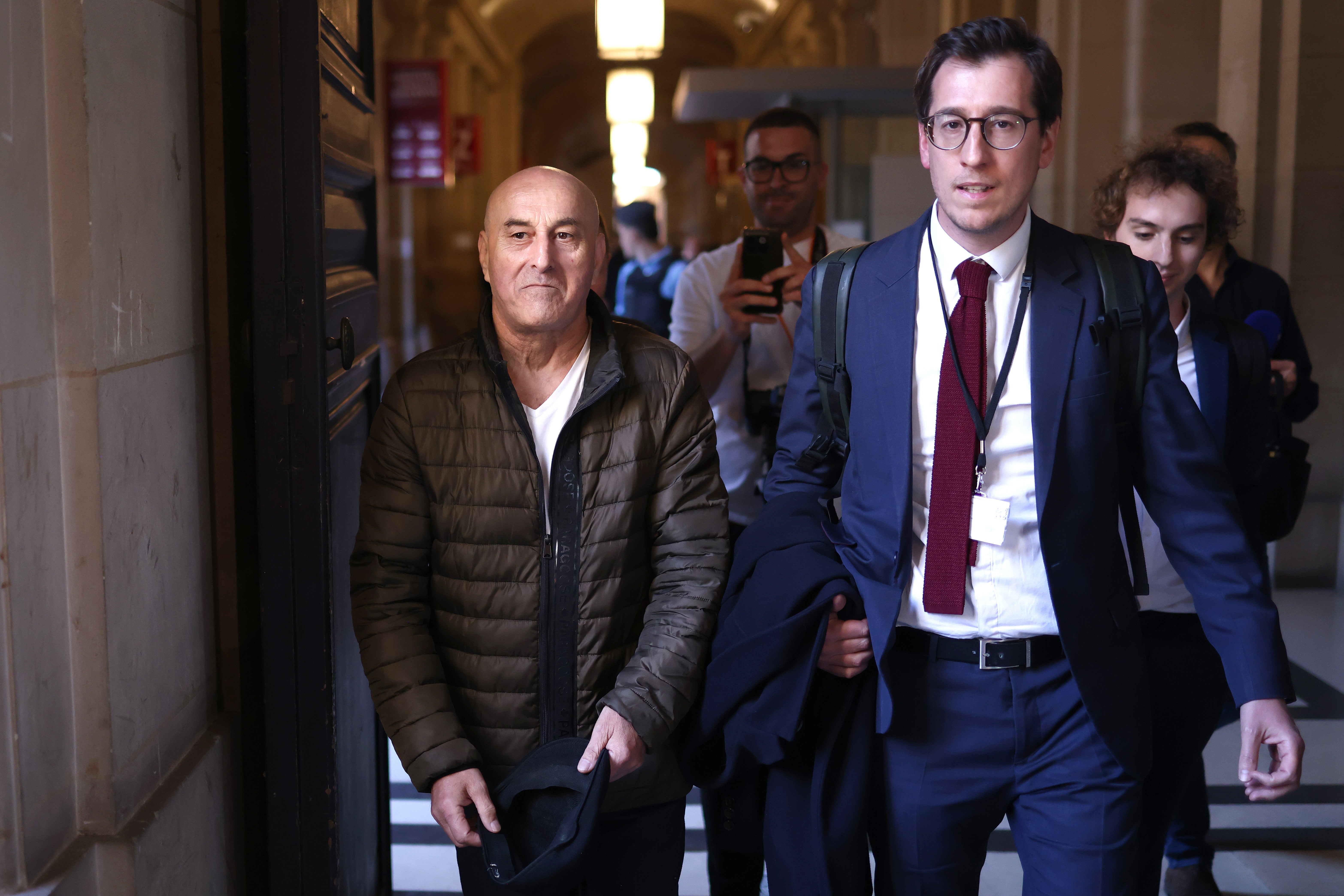 Defendant Yunice Abbas and his lawyer Gabriel Dumenil leave the Court of Assize