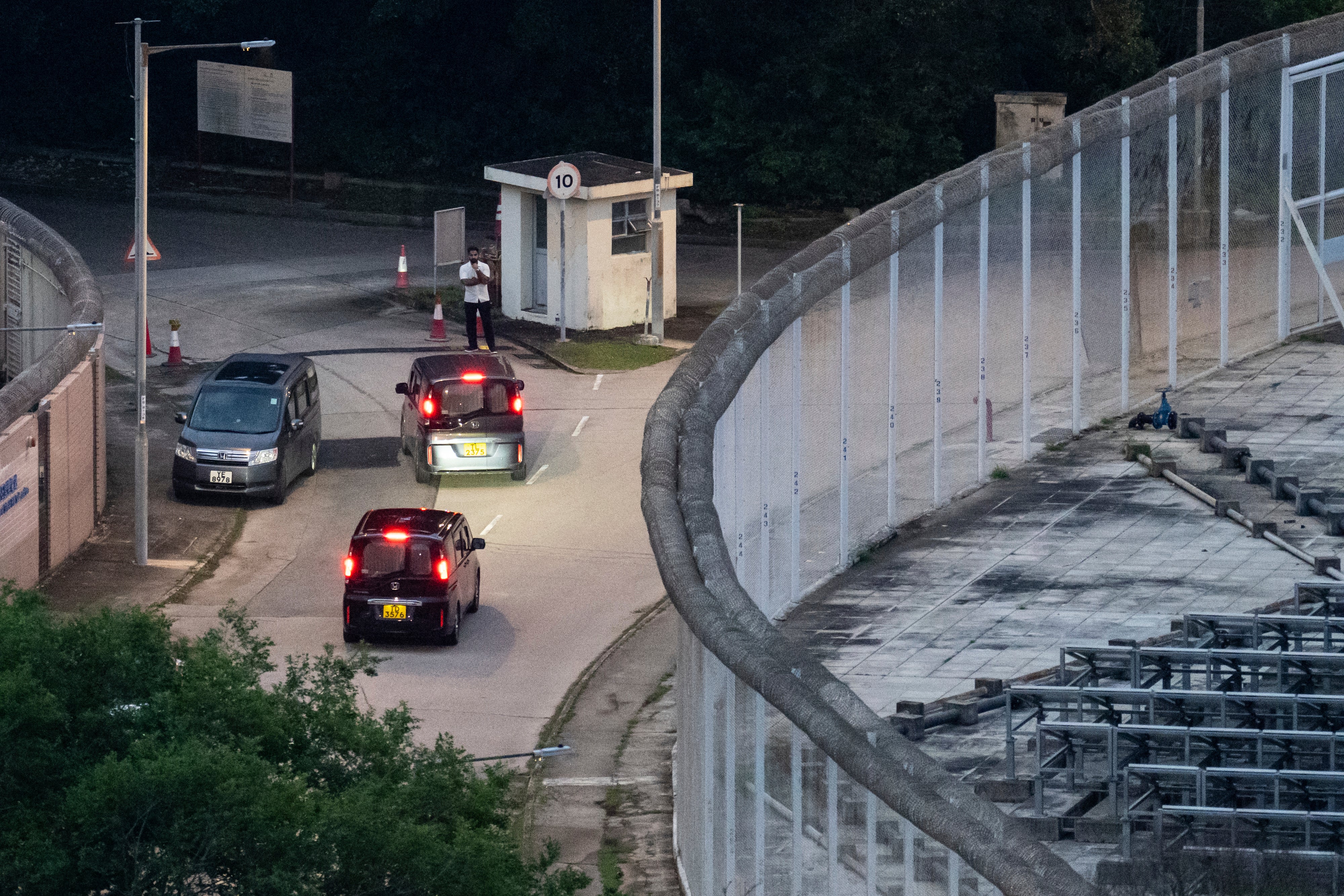 Vehicles believed to be carrying former pro-democracy lawmaker Gary Fan, who was released after four years for his conviction under the national security law, leaves the Shek Pik Prison in Hong Kong, Tuesday, 29 April 2025